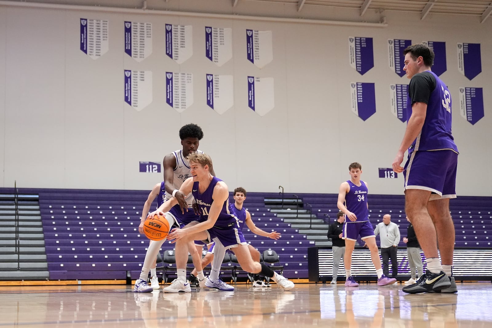 St. Thomas guard Drake Dobbs (11) takes part in drills during NCAA college basketball practice, Wednesday, Feb. 26, 2025, in St. Paul, Minn. (AP Photo/Abbie Parr)