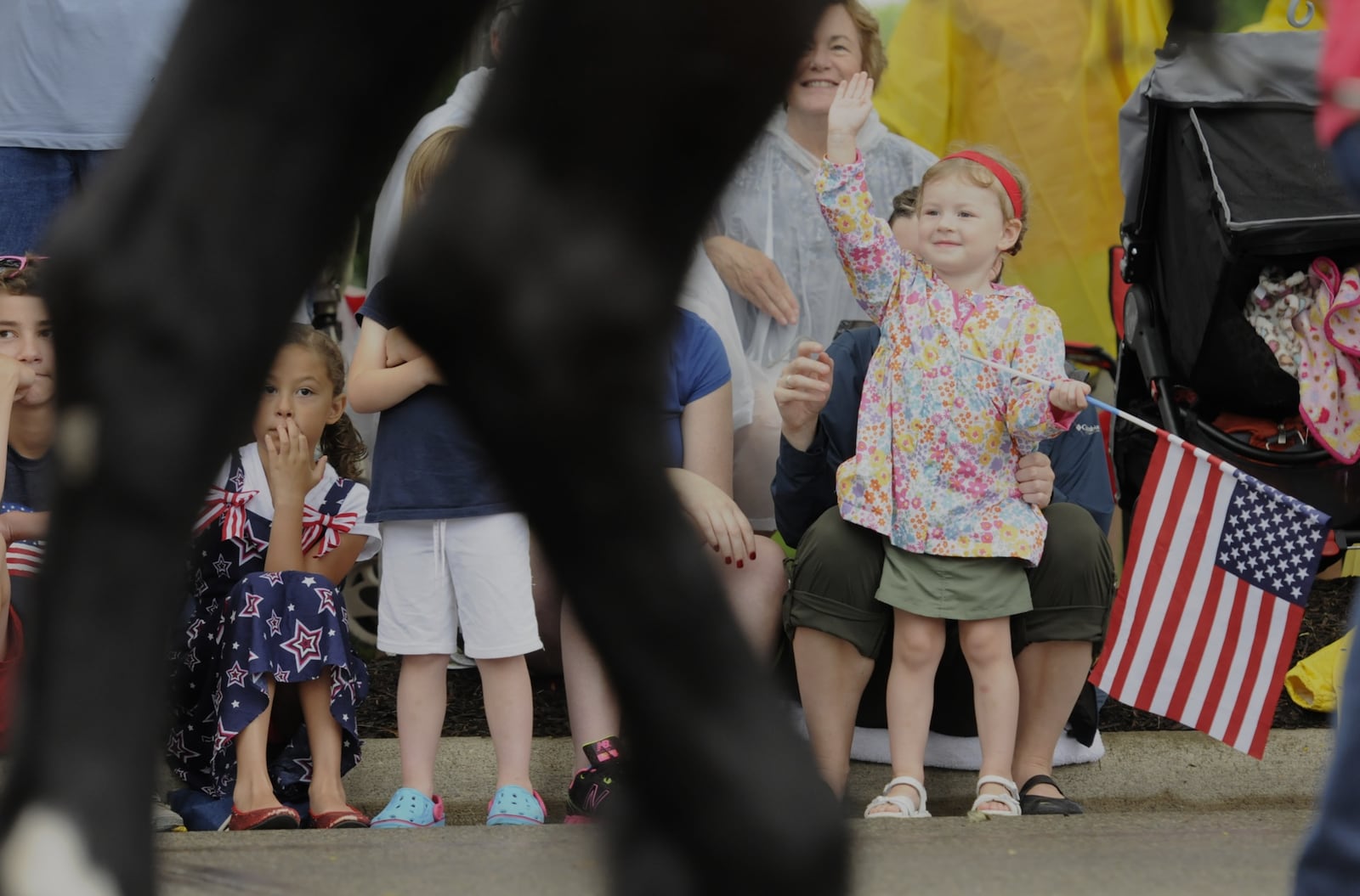 Amielia Hoffman, 3, holds a flag up as the parade passes during the Centerville Americana Festival Thursday, July 4, 2013. NICK GRAHAM / STAFF