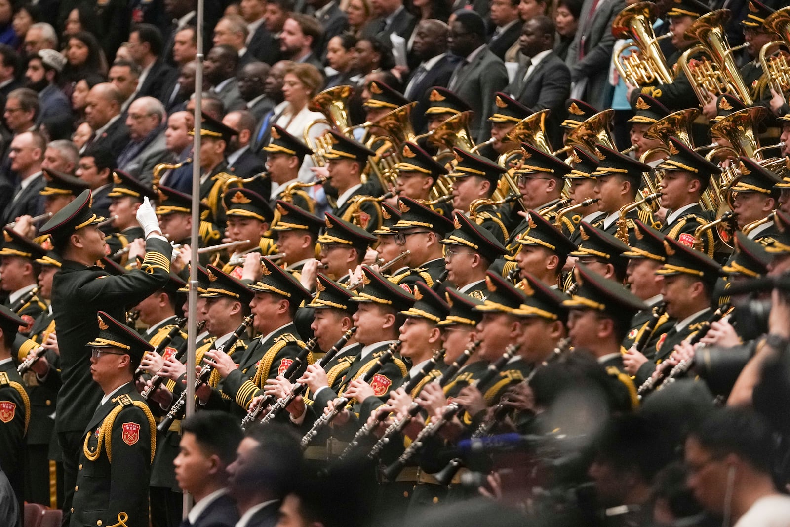 A conductor leads the military band as they perform the national anthem during the opening session of the National People's Congress (NPC) at the Great Hall of the People in Beijing, China, Wednesday, March 5, 2025. (AP Photo/Andy Wong)