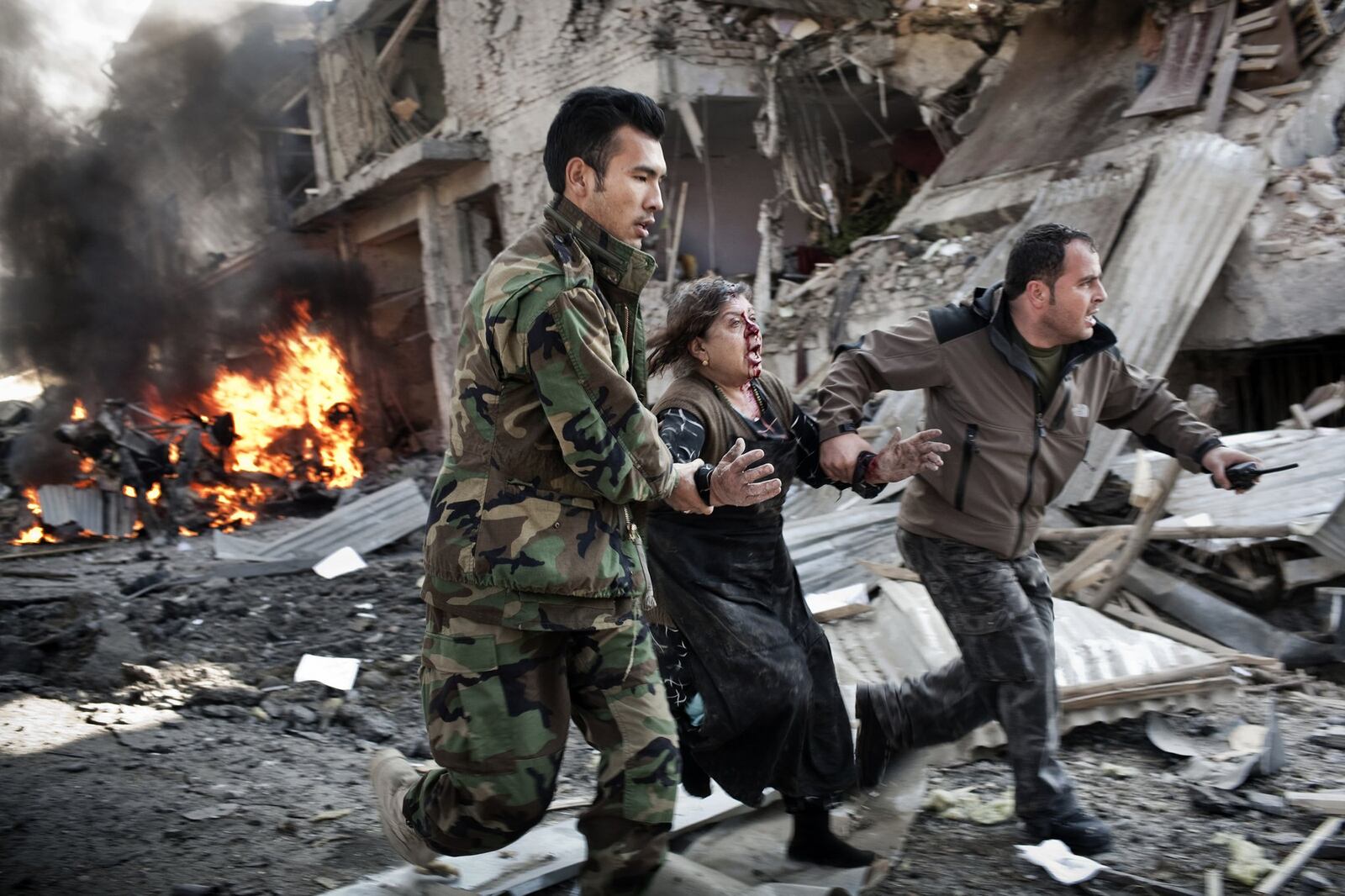 FILE — An Afghan women is rushed from the scene of a suicide car bomb in Kabul, Afghanistan, Dec. 15, 2013. America’s war in Afghanistan has now stretched into its 16th year, preoccupying three American presidencies and outlasting a dozen American military commanders. (Adam Ferguson/The New York Times)