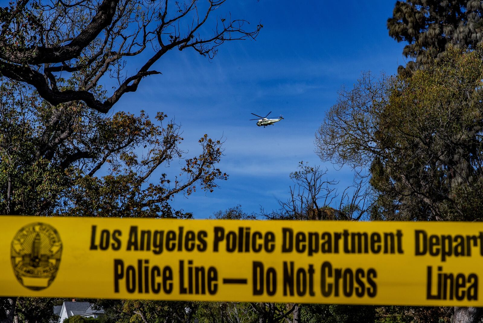 One of the Marine One helicopters flies over the fire-ravaged region the Palisades Fire zone damage as President Donald Trump toured the Palisades Fire zone damage in the Pacific Palisades neighborhood of Los Angeles Friday, Jan. 24, 2025. (AP Photo/Damian Dovarganes)