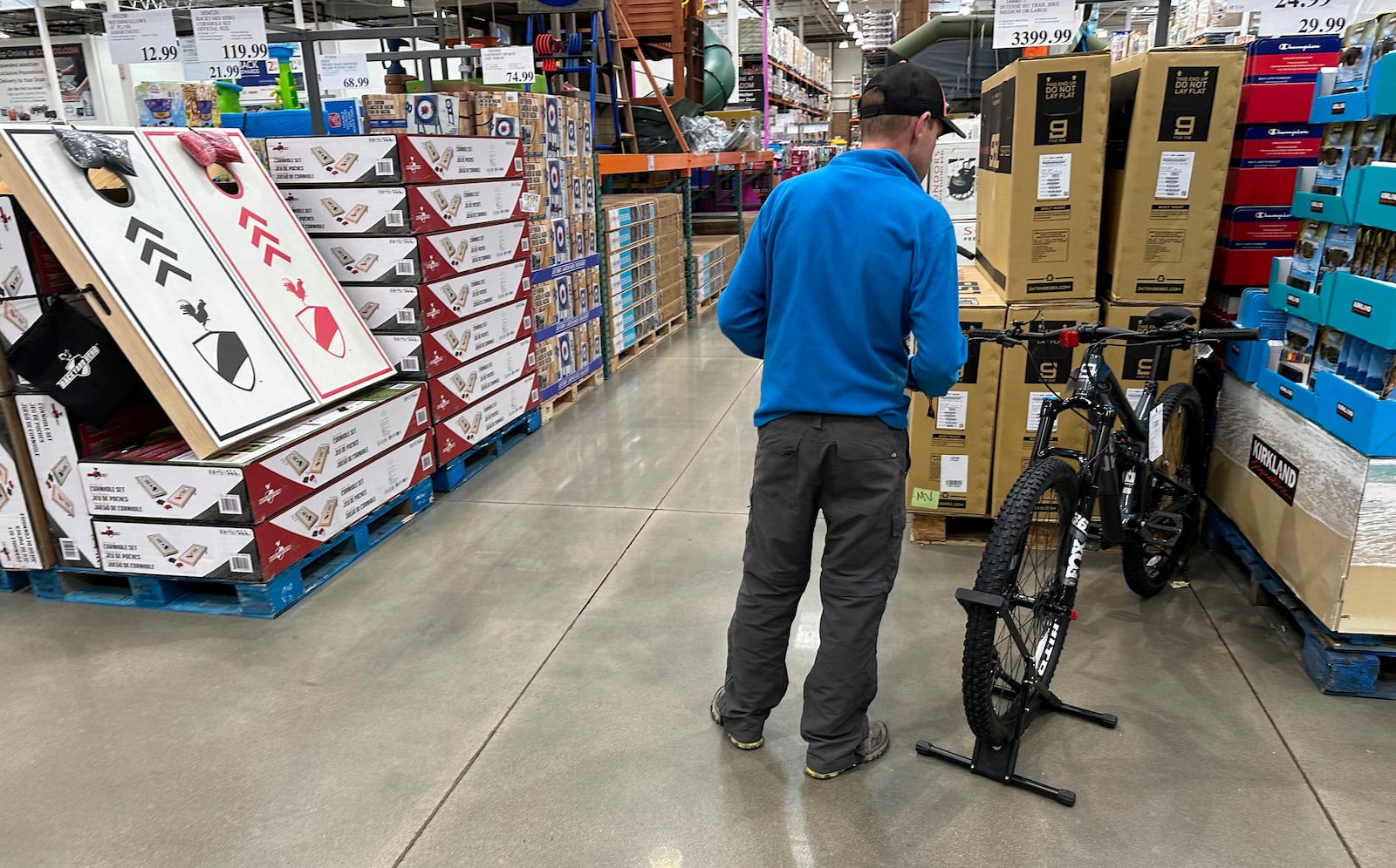 File - A shopper peruses a mountain bicycle on display in a Costco warehouse Wednesday, May 10, 2023, in Sheridan, Colo. On Tuesday, the Commerce Department releases U.S. retail sales data for April. Analysts who follow the retail industry estimate that the resumption of student loan payments could trim consumer spending by $14 billion a month or $305 per borrower.(AP Photo/David Zalubowski, File)