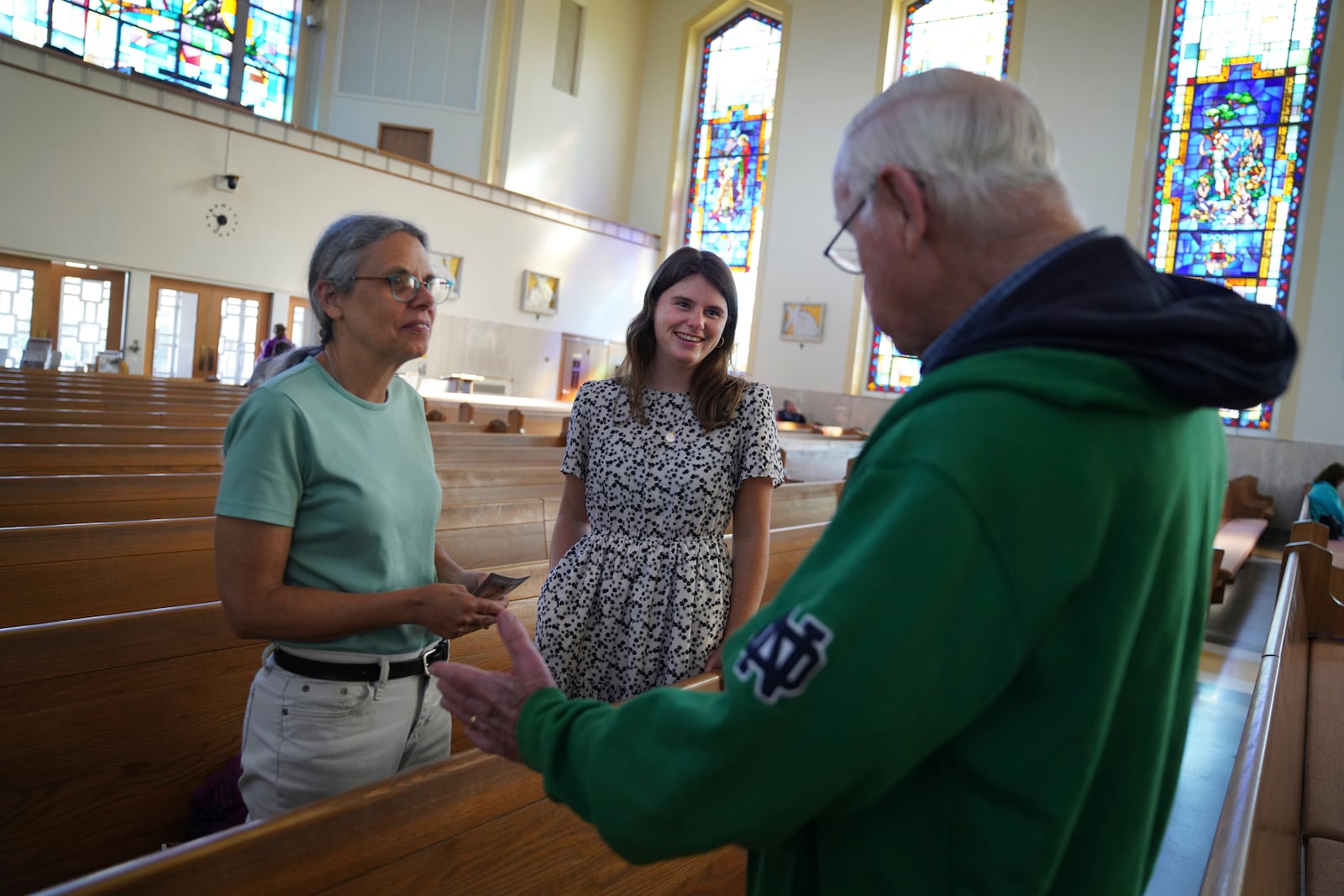 Peggy Stapleton, left, and her daughter Zoey, a current postulant at the Franciscan Sisters, T.O.R. of Penance of the Sorrowful Mother, talk with a fellow parishioner after morning Mass at their home church, St. Joan of Arc Catholic Church, in Hershey, Pa., Wednesday, July 3, 2024. (AP Photo/Jessie Wardarski)