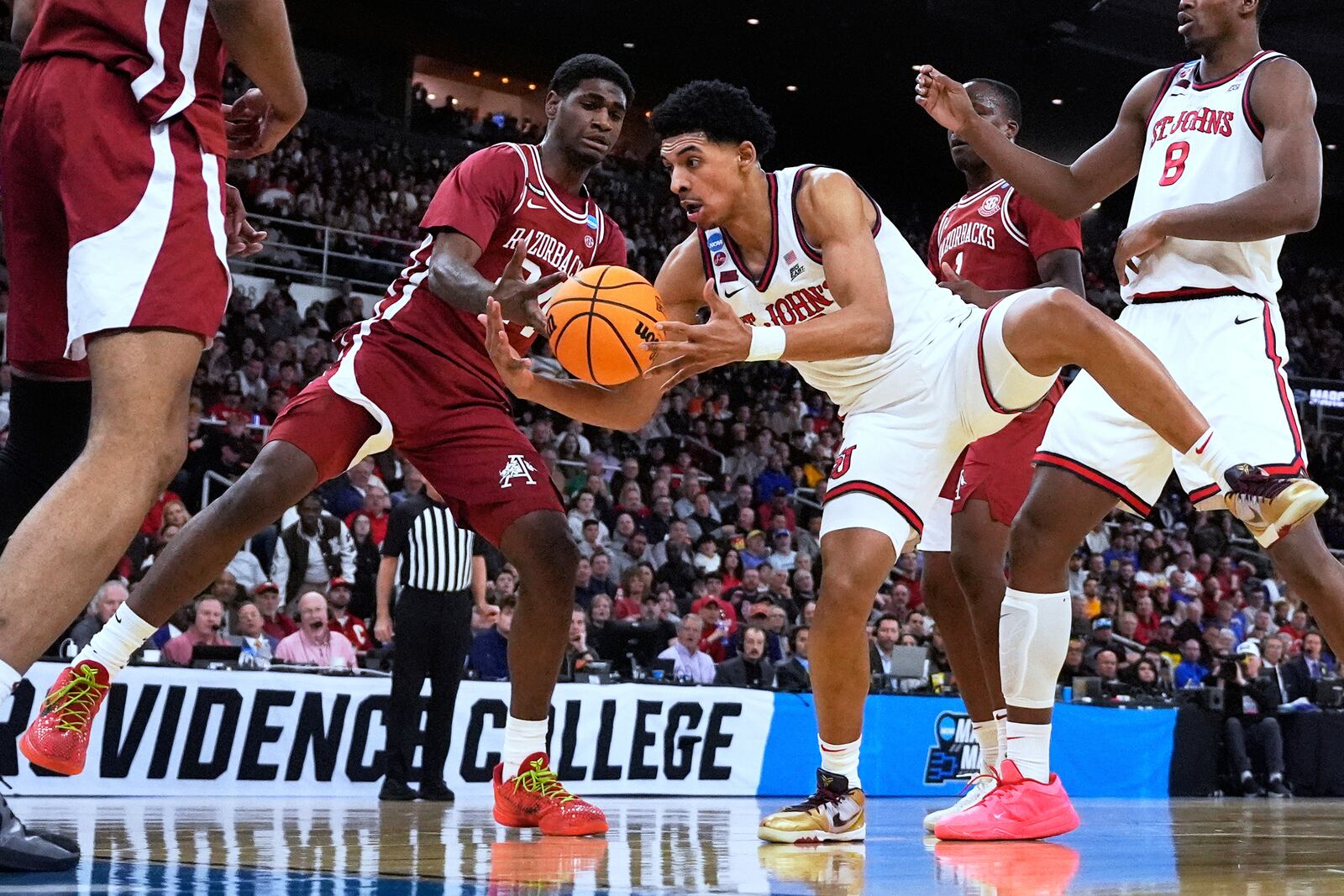 Arkansas forward Billy Richmond III, left, battles St. John's guard RJ Luis Jr., right, during the first half in the second round of the NCAA college basketball tournament, Saturday, March 22, 2025, in Providence, R.I. (AP Photo/Charles Krupa)