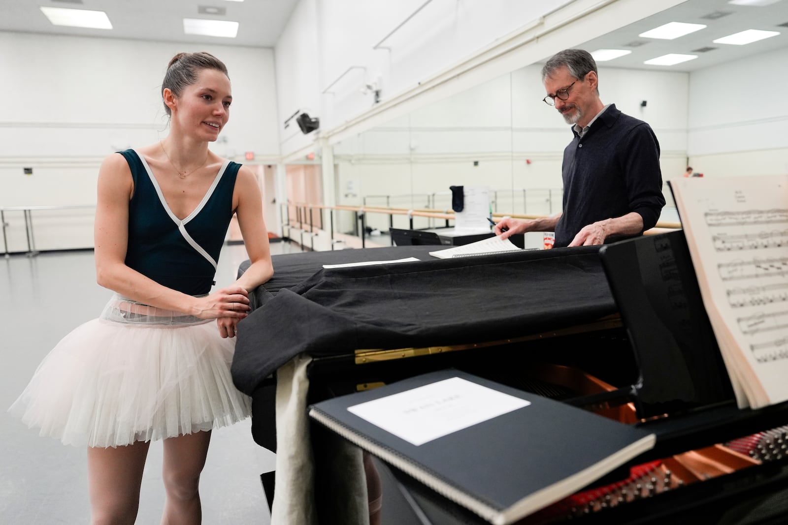 Unity Phelan, left, takes a break during a rehearsal for her role as Swan Queen in New York City Ballet's "Swan Lake," Tuesday, Feb. 25, 2025, in New York. (AP Photo/Julia Demaree Nikhinson)