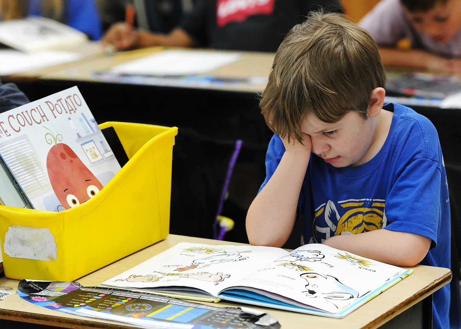 Northwoods Elementary in Englewood second grade student, A.J. Curtis, reads a book during free time in class. MARSHALL GORBY\STAFF