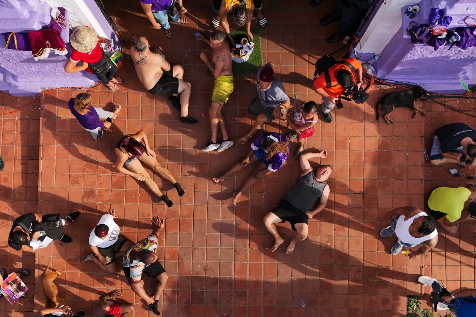 Pilgrims rest from crawling to San Felipe Church to honor the Black Christ in Portobelo, Panama, early Monday, Oct. 21, 2024, during a festival celebrating the iconic statue that was found on the shore in 1658. (AP Photo/Matias Delacroix)