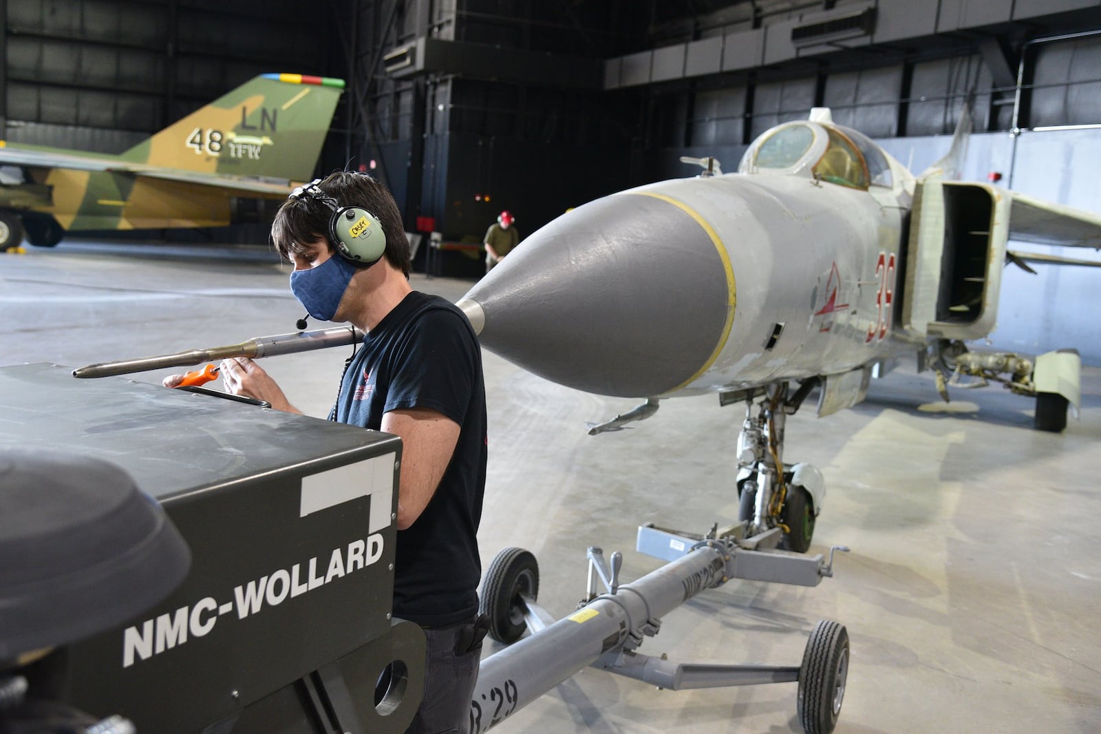 Museum restoration specialist Casey Simmons works on the Mikoyan-Gurevich MiG-23MS “Flogger-E” during the Cold War Gallery aircraft moves. These moves are intended to better tell the story of the Cold War and post-Cold War, as well as provide new views of the aircraft in these galleries. CONTRIBUTED/U.S. AIR FORCE/KEN LAROCK