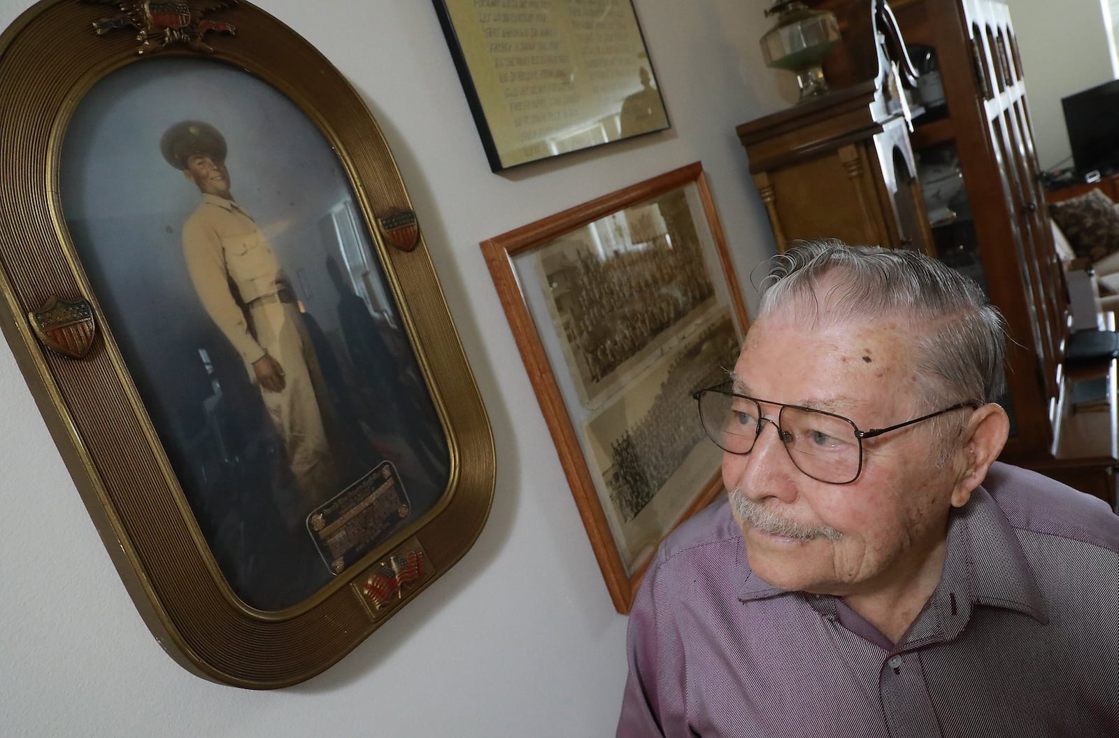 D-Day veteran Albert Carr comments about how thin he was when the picture of him in his Army uniform was taken 75 years ago. BILL LACKEY/STAFF