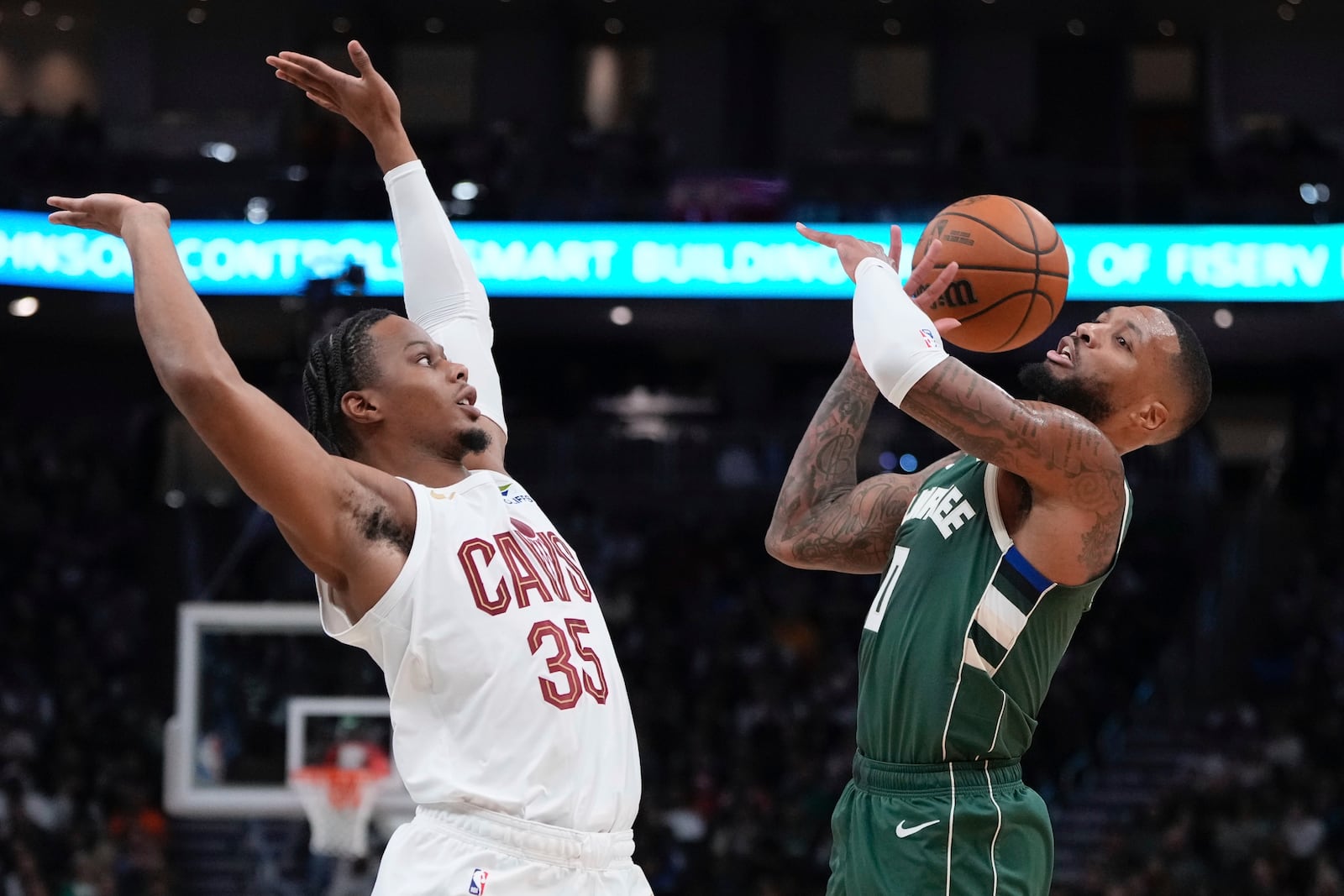 Milwaukee Bucks' Damian Lillard is fouled by Cleveland Cavaliers' Isaac Okoro during the first half of an NBA basketball game Saturday, Nov. 2, 2024, in Milwaukee. (AP Photo/Morry Gash)