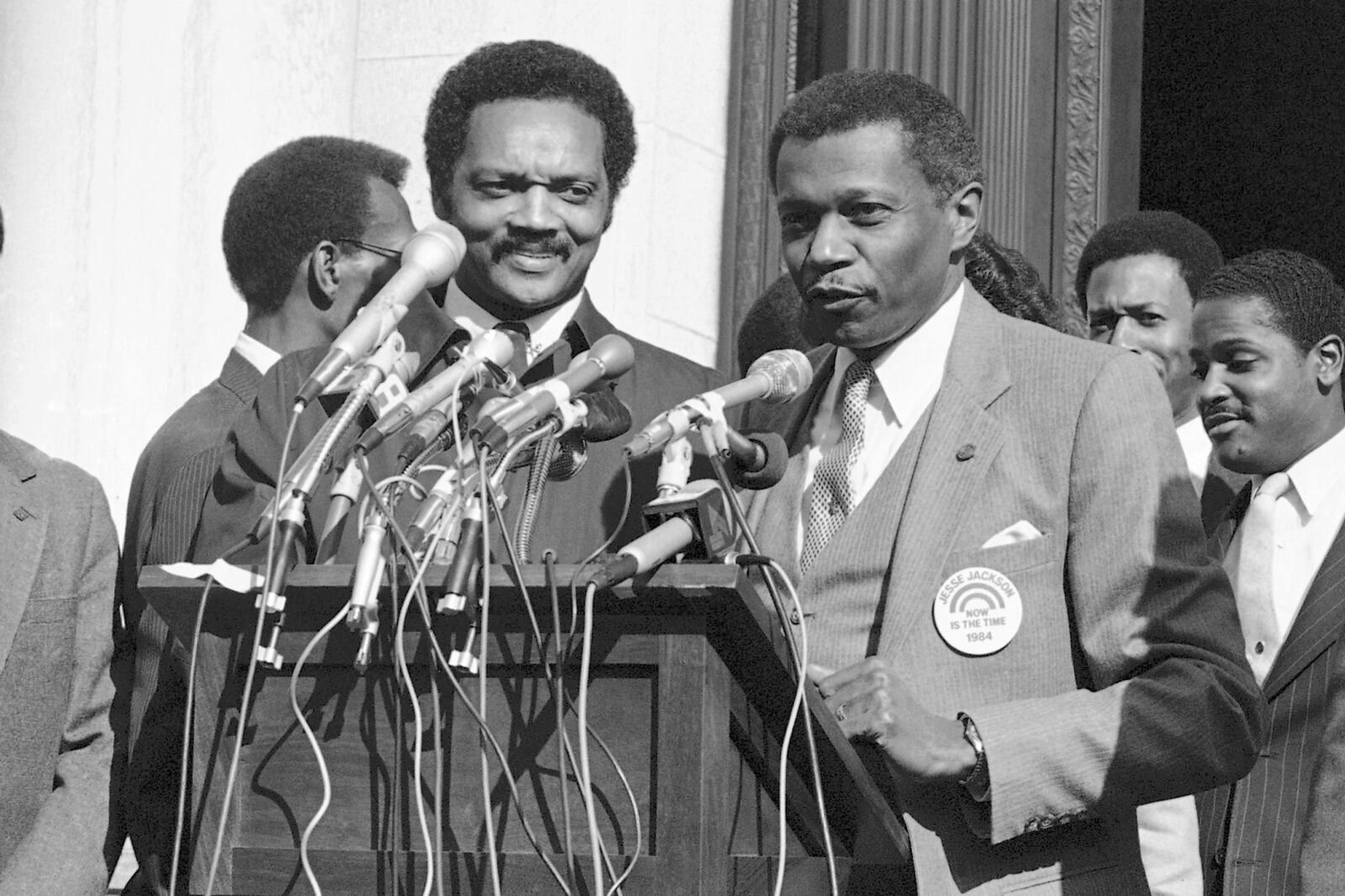 FILE - Hartford Mayor Thirman Milner, right, gives his support to the candidacy of Rev. Jesse Jackson in front of the Hartford city hall on March 26, 1984. (AP Photo/Don Heiny, File)