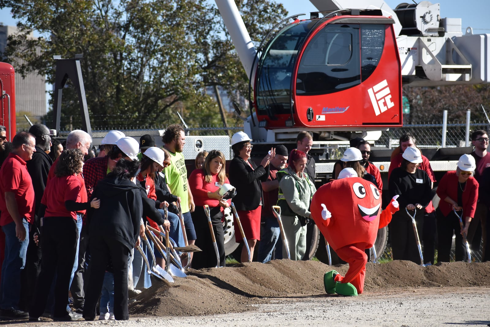 Dayton Foodbank Inc. workers, volunteers and other team members join in breaking ground at the location of a new $4.5 million community building for the Foodbank. SAM WILDOW\STAFF