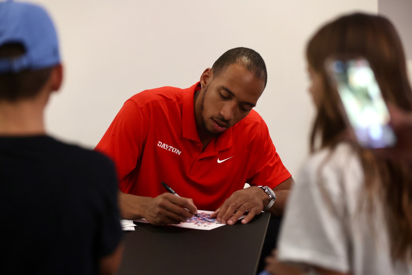 Dayton's Zed Key signs an autograph during a meet and greet with fans on Wednesday, Oct. 9, 2024, at UD Arena. David Jablonski/Staff