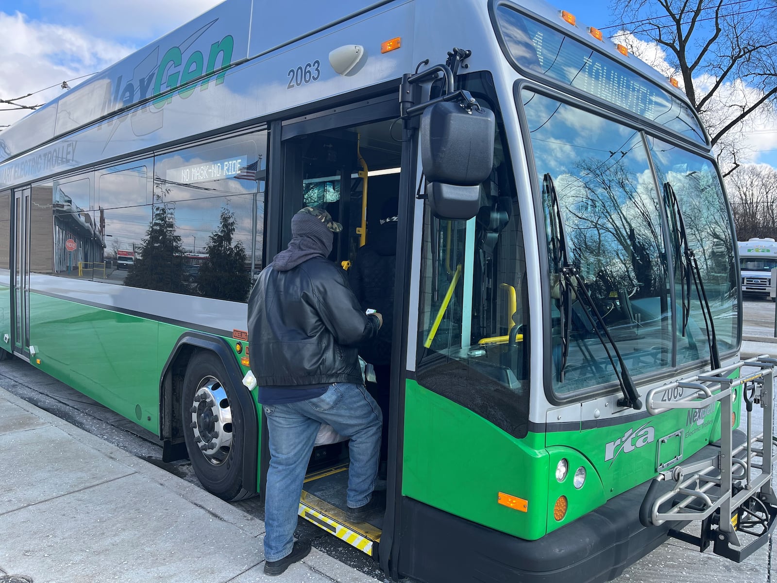 A passenger boards a bus at the Eastown Transit Center. CORNELIUS FROLIK / STAFF