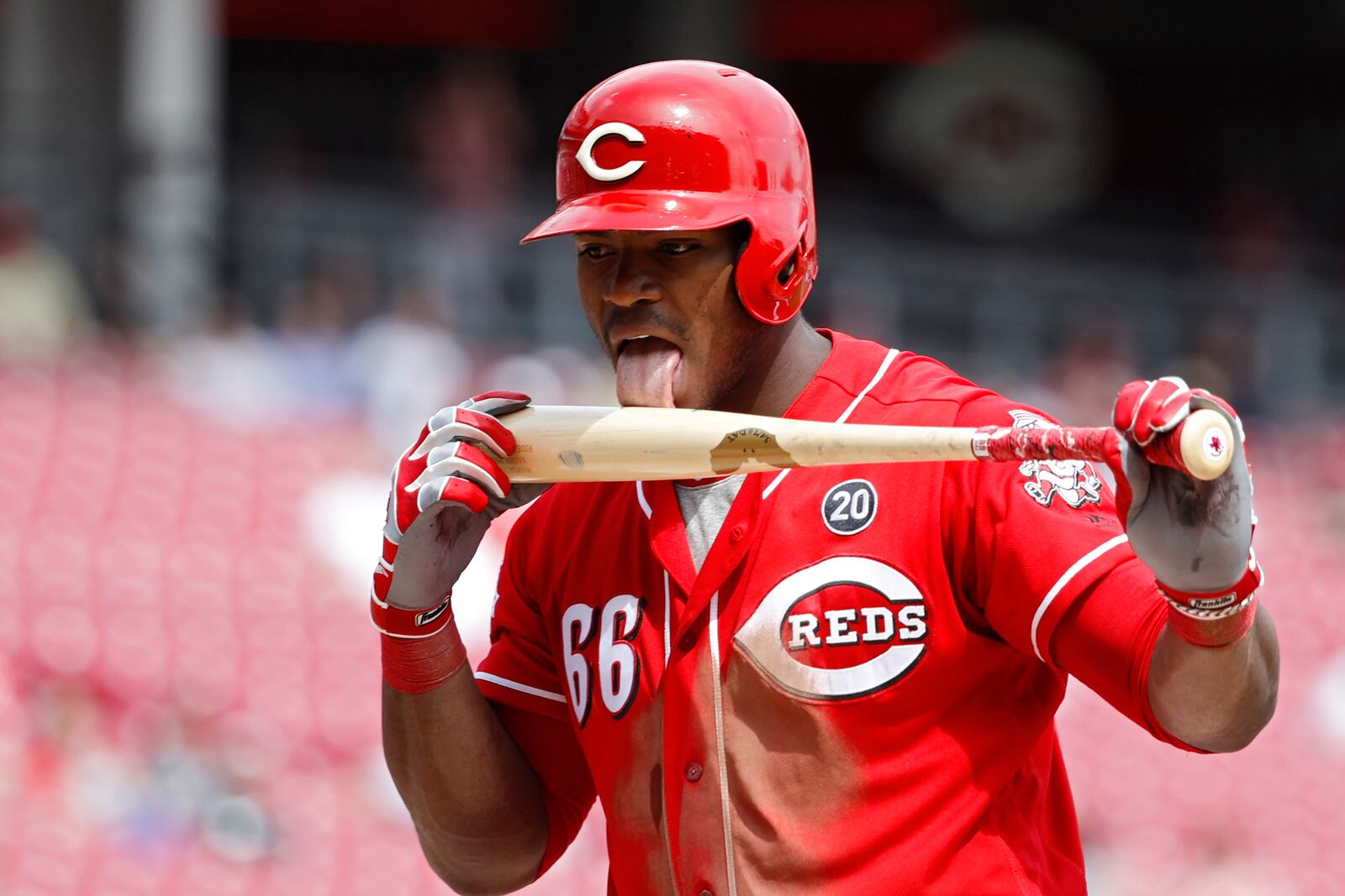 CINCINNATI, OH - APRIL 11: Yasiel Puig #66 of the Cincinnati Reds licks his bat after fouling off a pitch in the seventh inning against the Miami Marlins at Great American Ball Park on April 11, 2019 in Cincinnati, Ohio. The Reds won 5-0. (Photo by Joe Robbins/Getty Images)