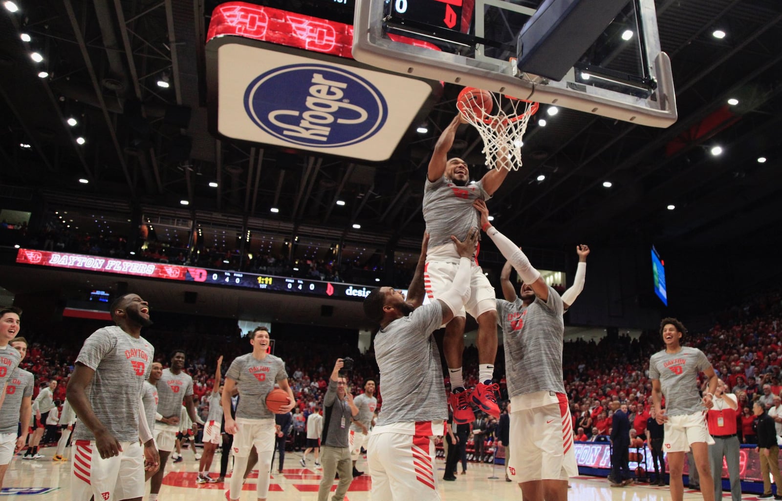 Dayton’s Trey Landers and Obi Toppin help Camron Greer attempt a dunk before a game against Duquesne on Saturday, Feb. 23, 2020, at UD Arena. David Jablonski/Staff