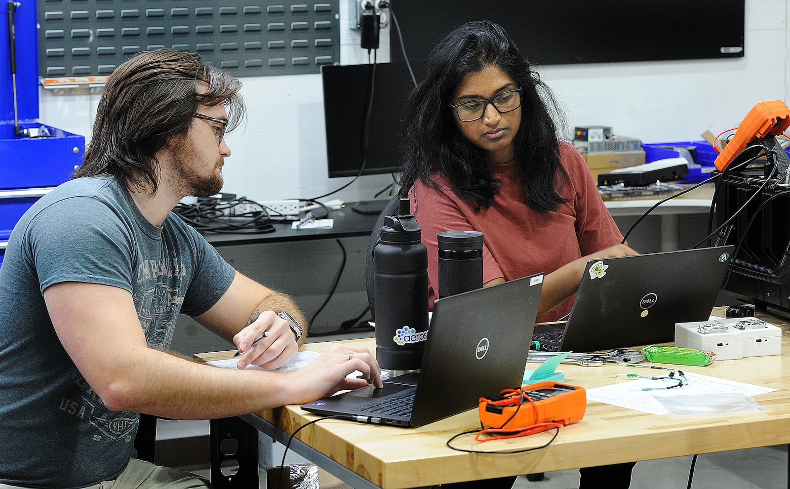 Aeroseal employees, Bobby Phillips, left, and Kruthi Anumandla, run tests on new products. MARSHALL GORBY\STAFF