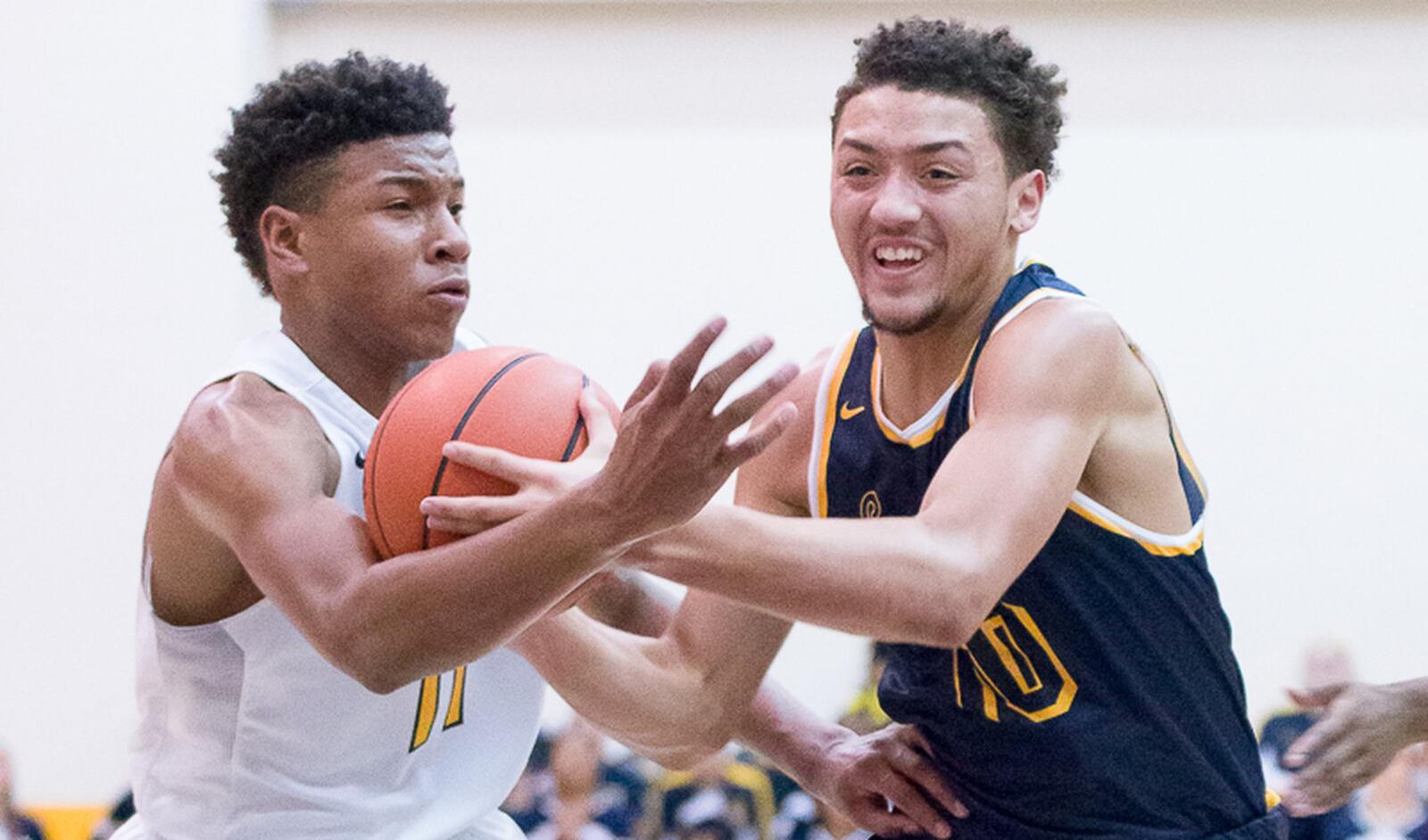 Springfield senior guard Danny Davis dribbles with pressure from Moeller’s Miles McBride during a nonconference game on Saturday in Cincinnati. Contributed Photo by Bryant Billing