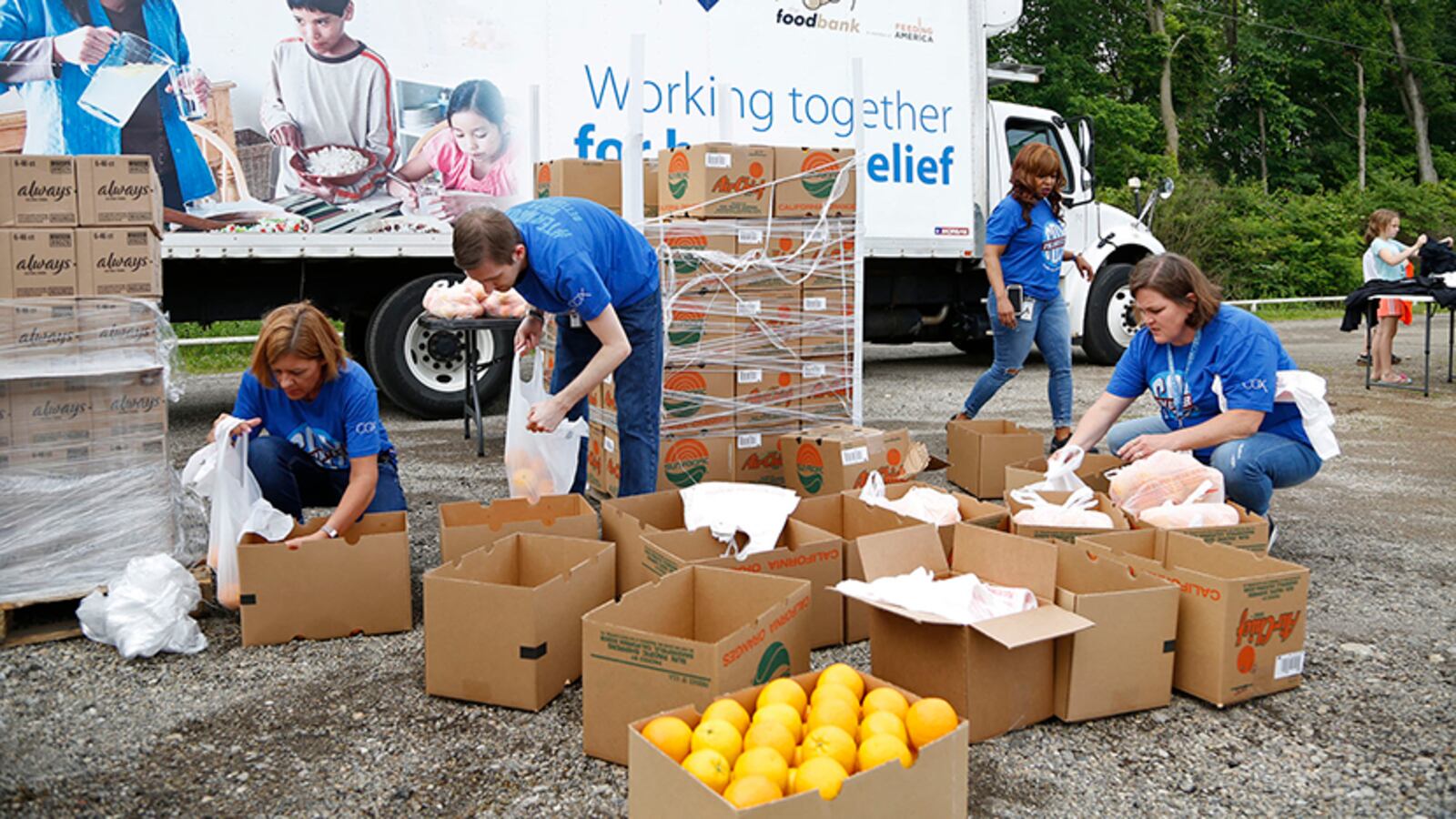 The Dayton Foodbank and Cox Media Group Ohio partnered with the North Dixie Drive In to aid in tornado relief efforts and gave away bottled water and food to those in need on Wednesday at the drive-in on North Dixie Drive.  TY GREENLEES / STAFF