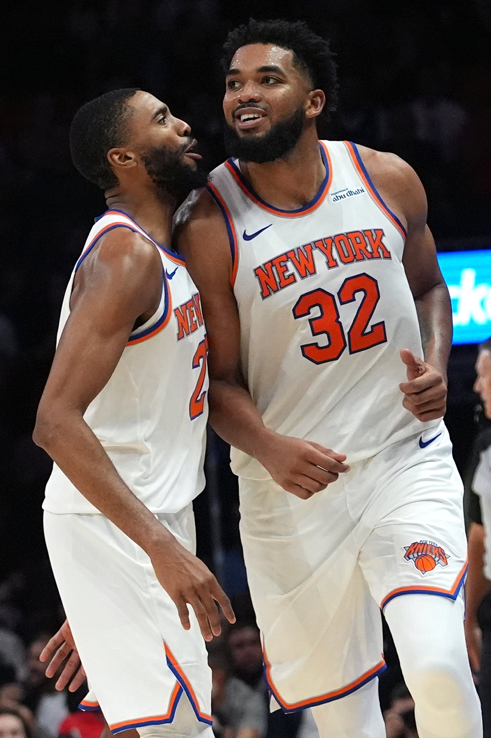 New York Knicks center Karl-Anthony Towns (32) reacts after scoring during the second half of an NBA basketball game against the Miami Heat, Wednesday, Oct. 30, 2024, in Miami. At left is New York Knicks forward Mikal Bridges, (AP Photo/Lynne Sladky)