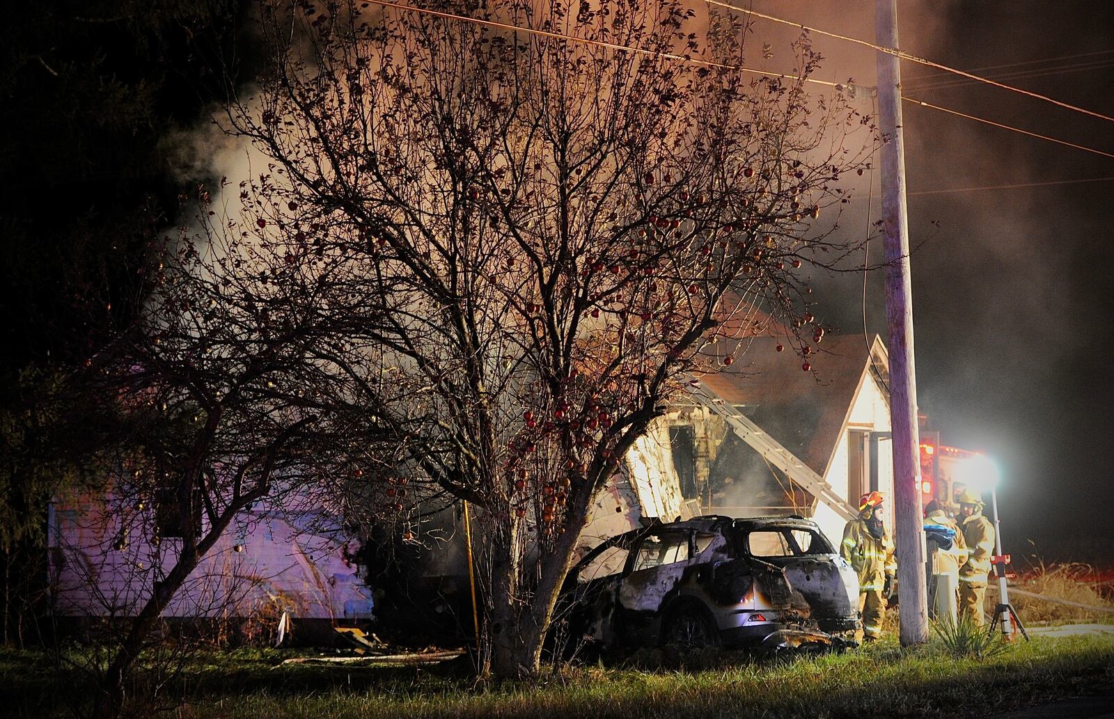 One person is dead after a car crashed into a house and both caught fire Wednesday evening, Dec. 8, 2021, in the 9900 block of state Route 235 in Champaign County on the border with Logan County. MARSHALL GORBY/STAFF