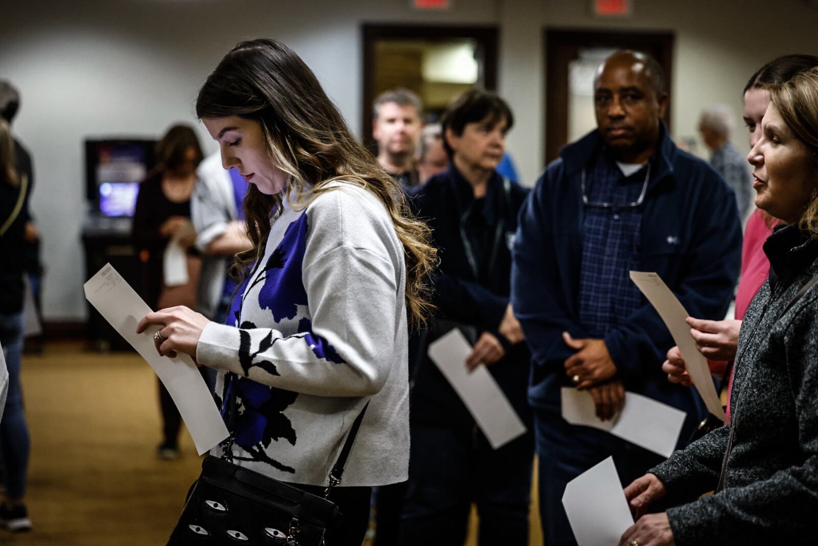 File - Leeanna Price, left, stands in line to case her ballot in November 2023 at St. Leonard in Centerville. Jim Noelker/Staff