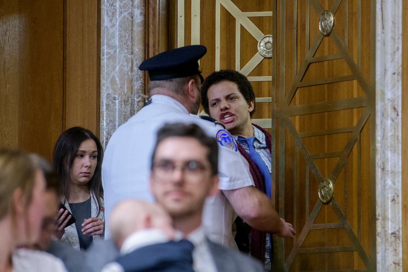 A protestor interrupts Chris Wright, President-elect Donald Trump's nominee to be Secretary of Energy, as he testifies during a Senate Committee on Energy and Natural Resources hearing for his pending confirmation, on Capitol Hill, Wednesday, Jan. 15, 2025, in Washington. (AP Photo/Rod Lamkey, Jr.)