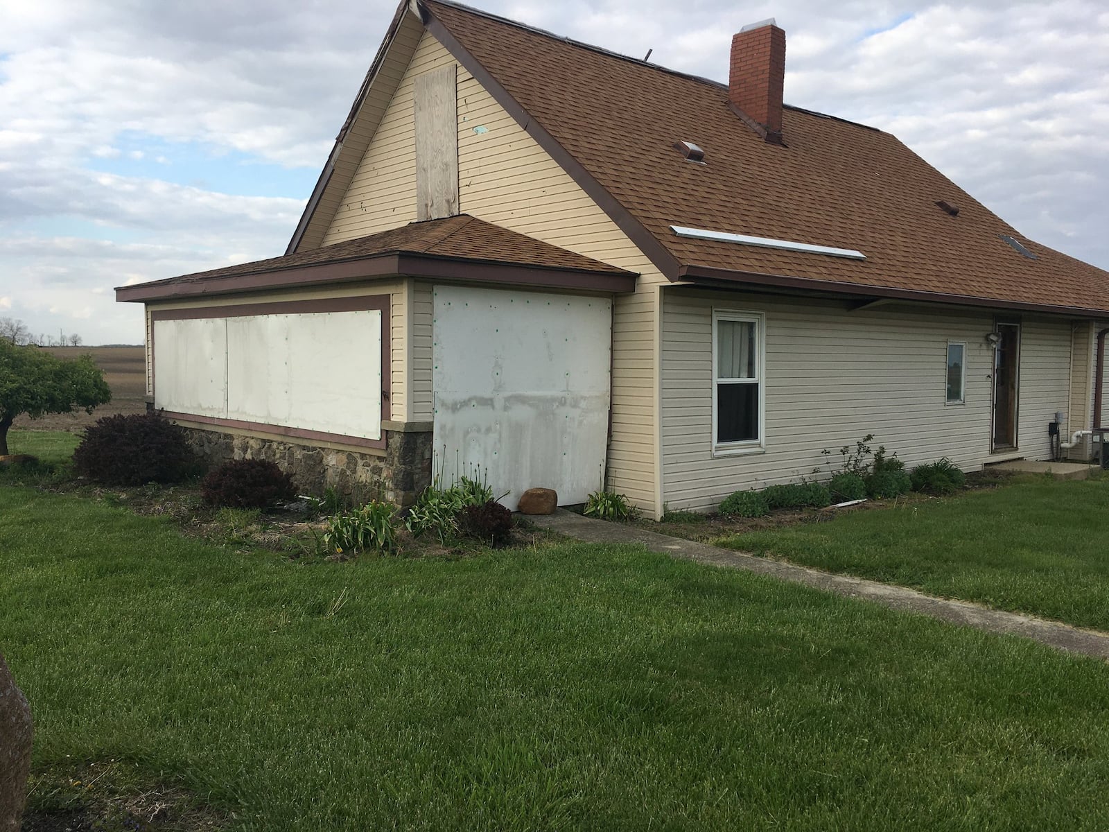 Plywood still covers the windows and tarp tops the roof of Ruth Barron’s family farm home in Jamestown. They have lived in a house rented from a neighbor down the road since the storm and say repairs are delayed by fights with their insurance company.