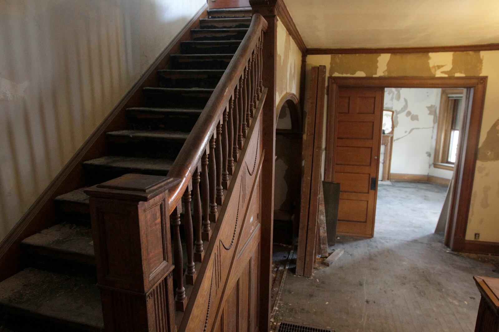 During renovaton of the historic Cox House at Grand and Salem avenues, ownerChris Lewis has removed added interior walls, openeing up the main staircase and revealing two sets of pocket doors hidden away for years. LISA POWELL / STAFF