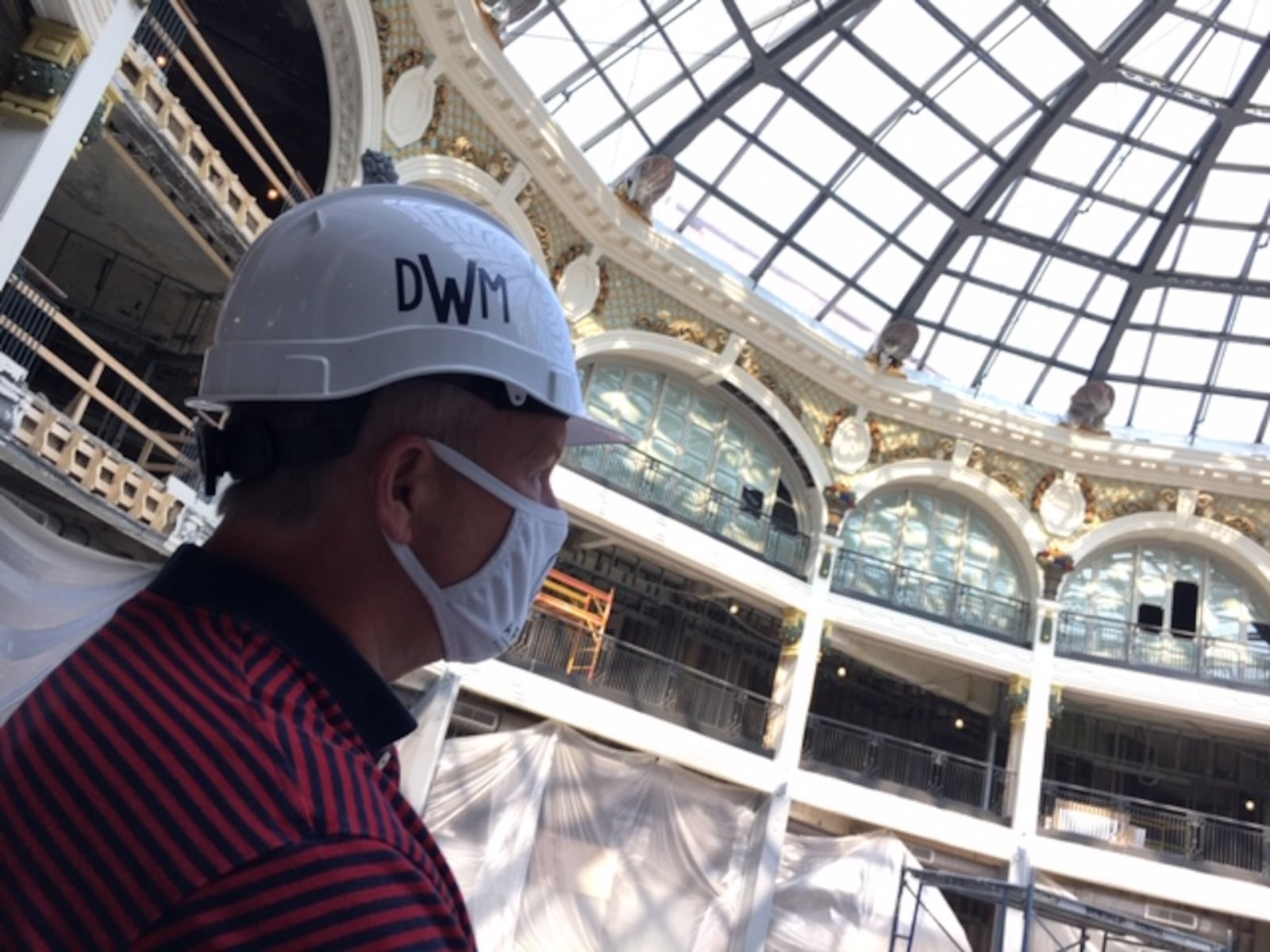 Dave Williams, senior director of real estate development at Cross Street Partners, surveys work at the Dayton Arcade last month. THOMAS GNAU/STAFF