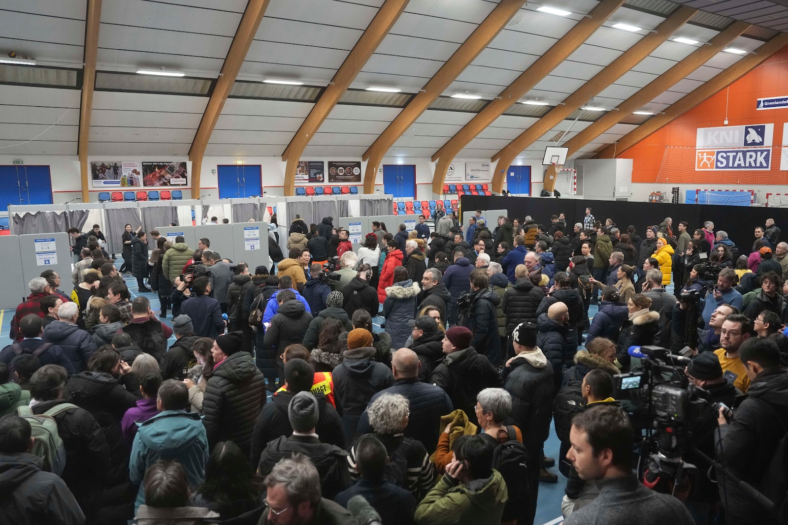 People line up at a polling station to cast their vote in parliamentary elections, in Nuuk, Greenland, Tuesday, March 11, 2025. (AP Photo/Evgeniy Maloletka)