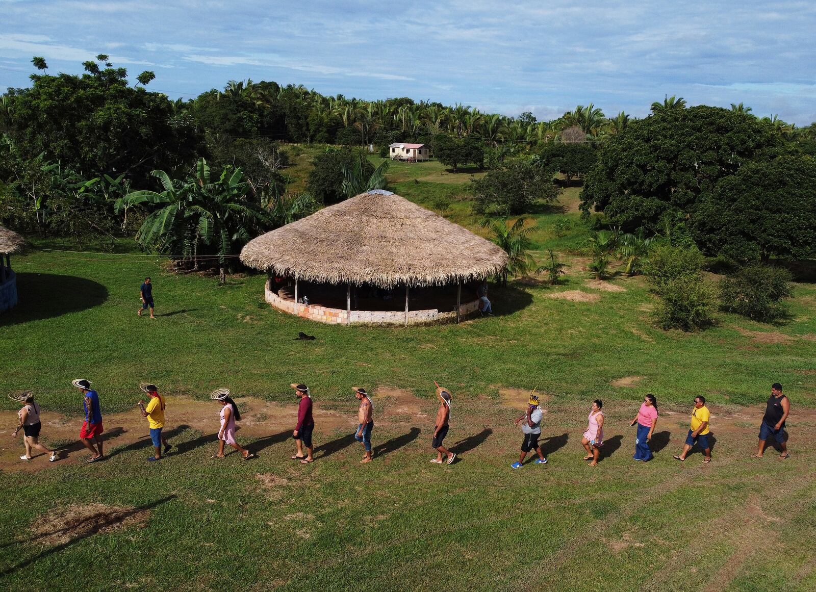 Members of the Mura Indigenous community walk to participate in a gathering of leaders, in the Moyray village, in Autazes, Amazonas state, Brazil, Friday, Feb. 21, 2025. (AP Photo/Edmar Barros)