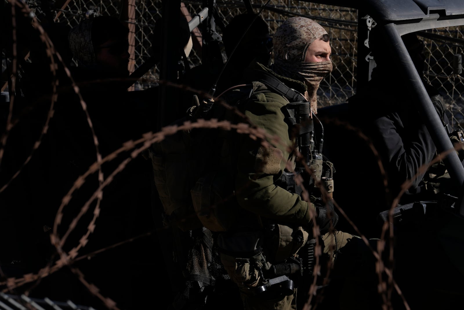 An Israeli soldier stands next to armoured vehicle before crossing the security fence, moving towards the so-called Alpha Line that separates the Israeli-controlled Golan Heights from Syria, in the town of Majdal Shams, Friday, Dec. 13, 2024. (AP Photo/Matias Delacroix)