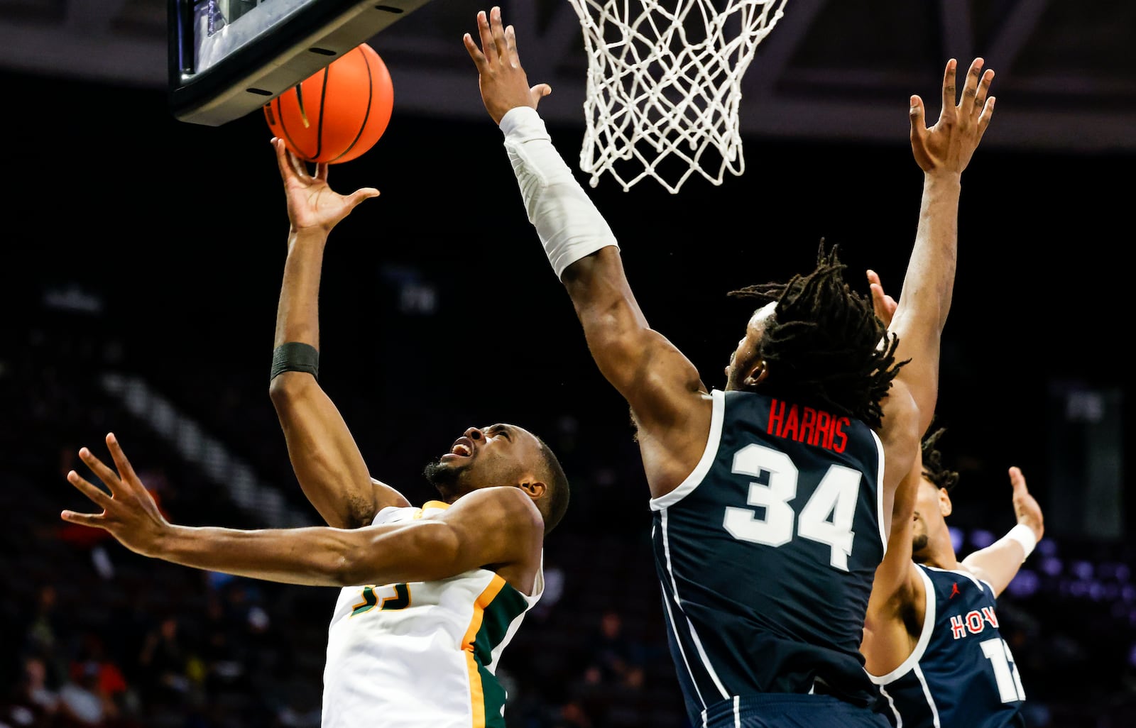 Norfolk State's Jack Doumbia (33) shoots against Howard's Bryce Harris (34) during an NCAA college basketball game in Mid-Eastern Athletic Conference men's tournament semifinals Friday, March 15, 2024, in Norfolk, Va. (Billy Schuerman/The Virginian-Pilot via AP)