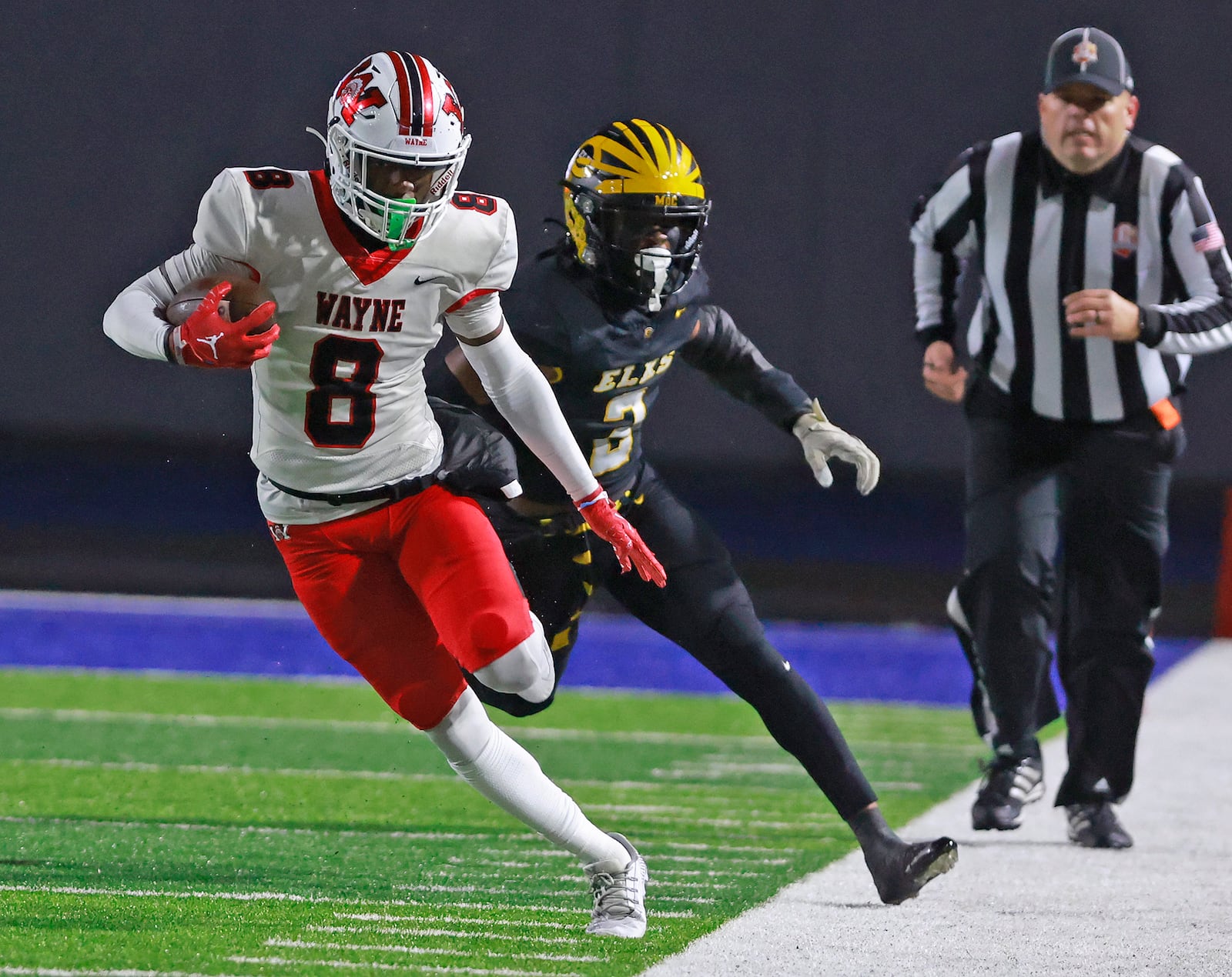 Wayne's Jamier Averette-Brown tries to stay in bounds as he's chased by Centerville's Gavin Monturo during Friday's regional championship game. BILL LACKEY/STAFF