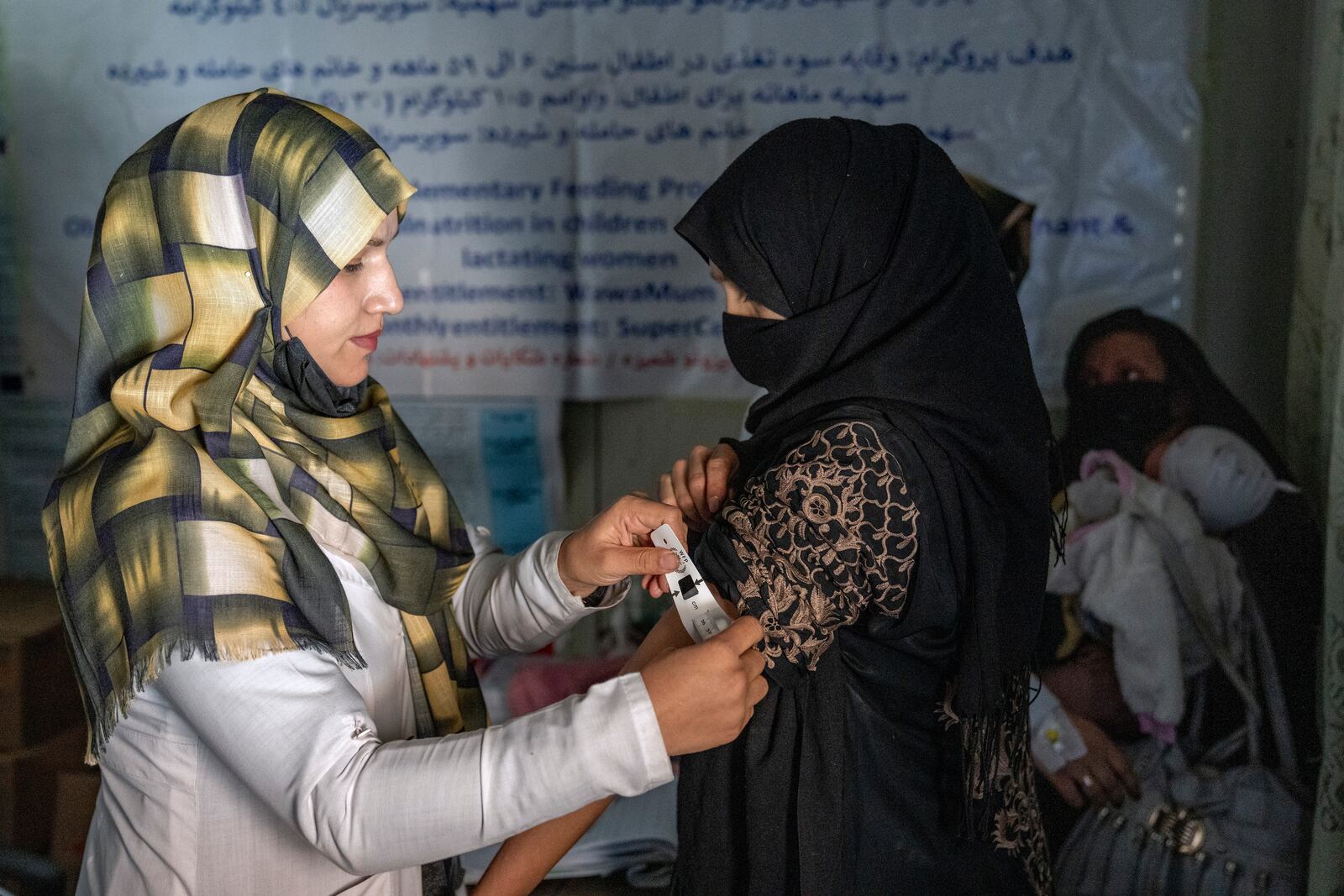 FILE -An Afghan woman is checked by a nutritionist at a clinic run by the WFP, in Kabul, Afghanistan, Thursday, Jan. 26, 2023. (AP Photo/Ebrahim Noroozi, File)