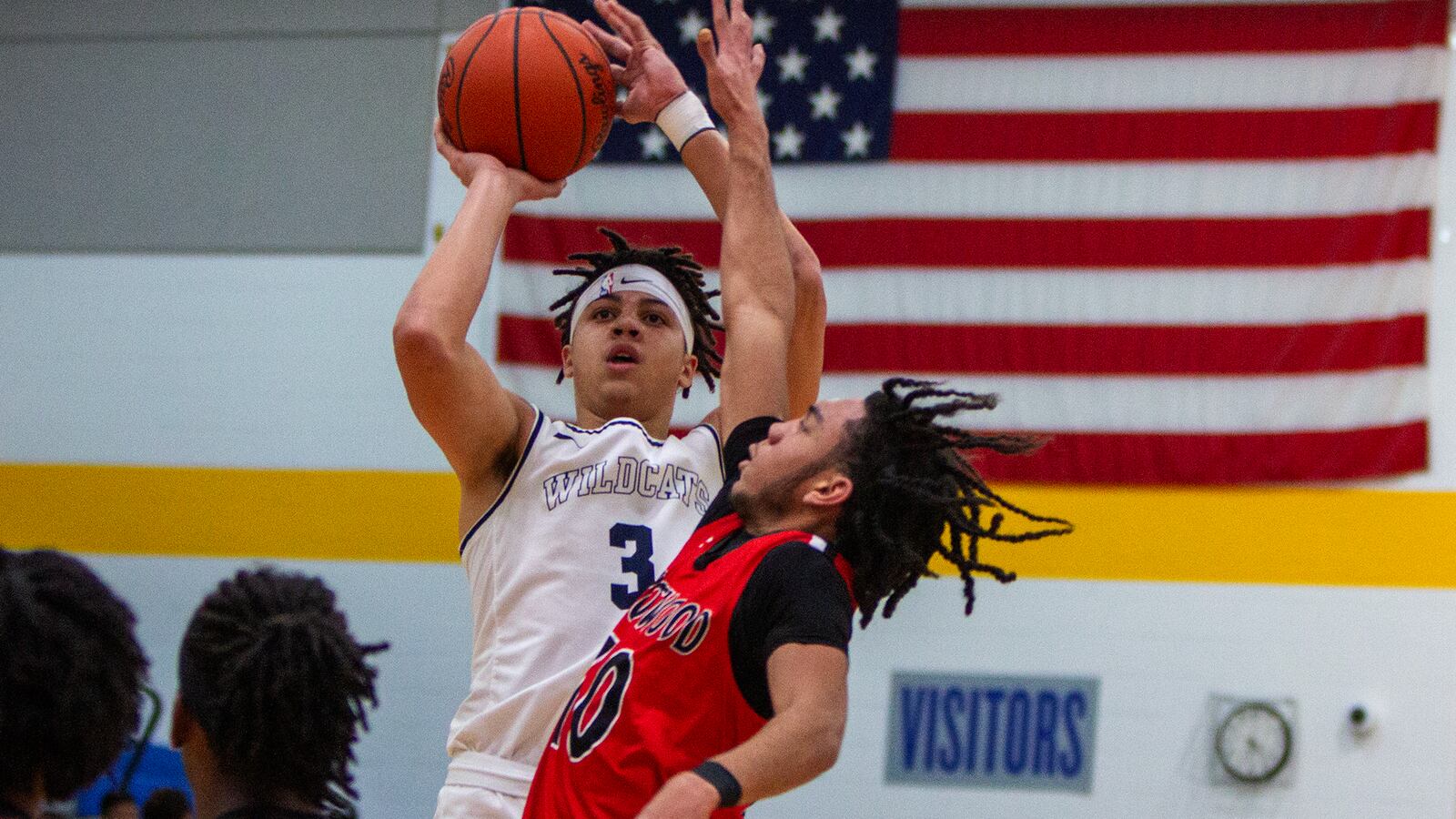 Springfield senior Bryce Washington shoots over Trotwood-Madison's Marlon Howard Jr. during the Rams' 55-53 victory Tuesday at Springfield. Jeff Gilbert/CONTRIBUTED