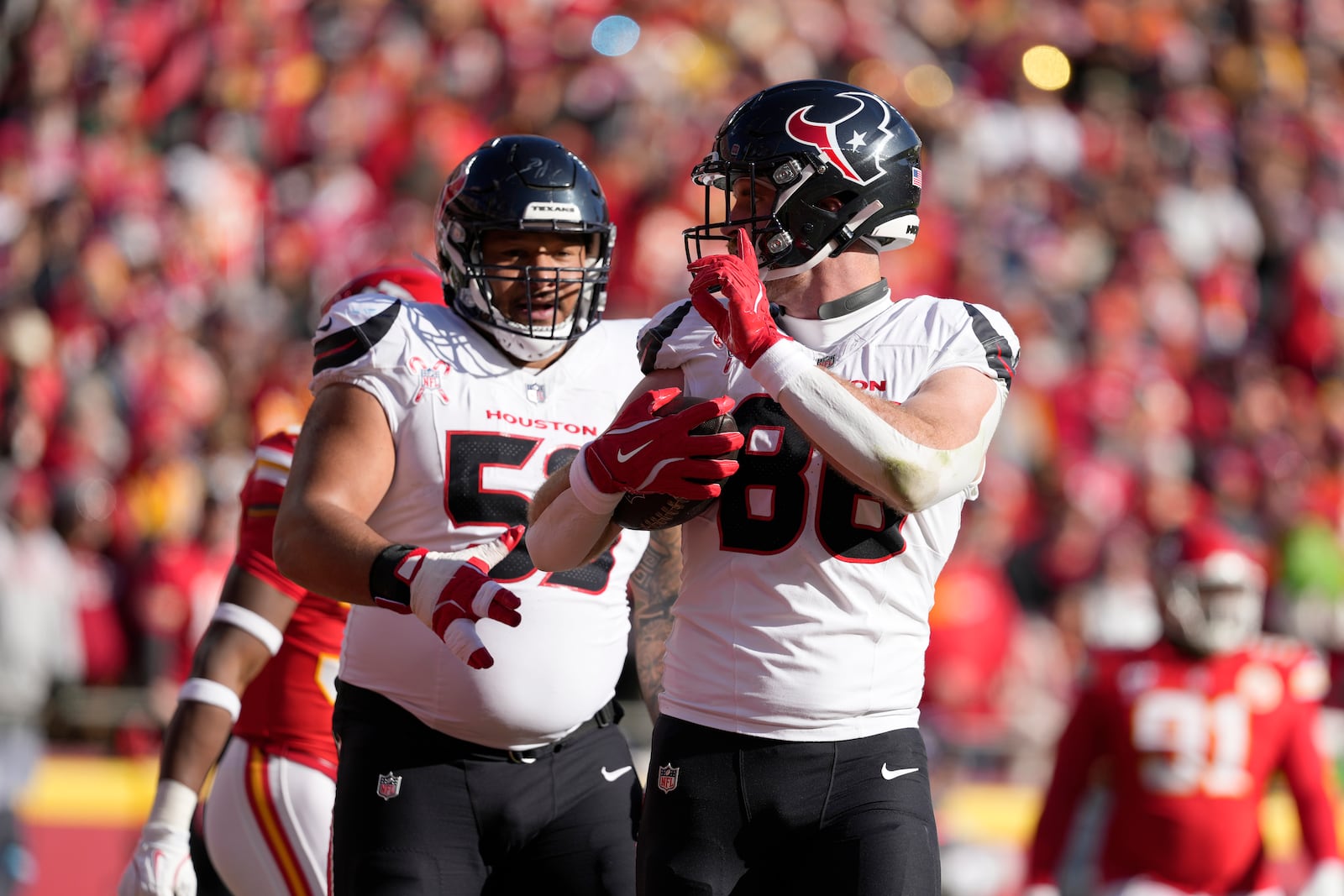 Houston Texans tight end Dalton Schultz (86) celebrates after catching a touchdown pass during the first half of an NFL football game against the Kansas City Chiefs Saturday, Dec. 21, 2024, in Kansas City, Mo. (AP Photo/Ed Zurga)