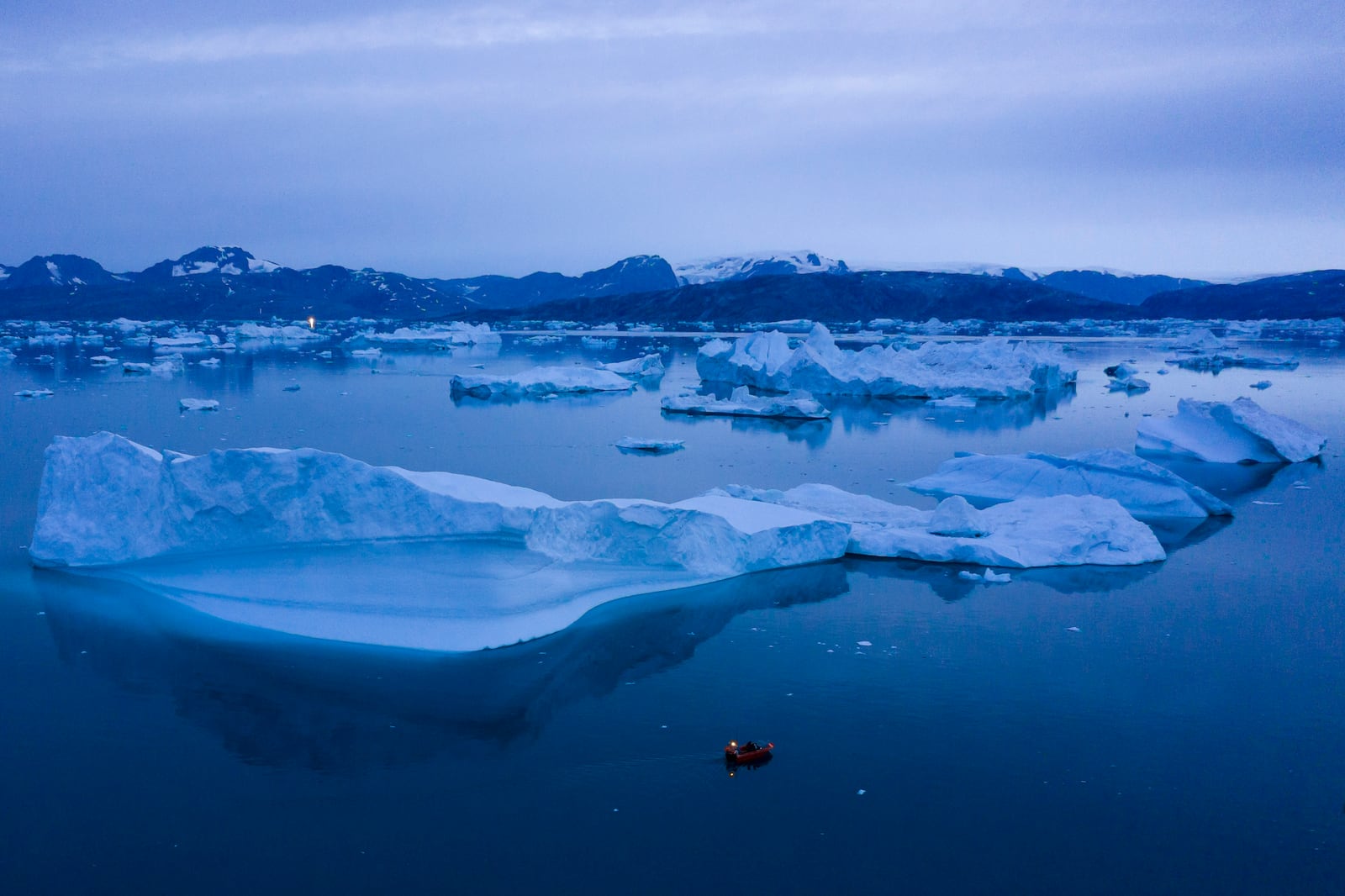 FILE - A boat navigates large icebergs near the town of Kulusuk, in eastern Greenland, on Aug. 15, 2019. (AP Photo/Felipe Dana, File)