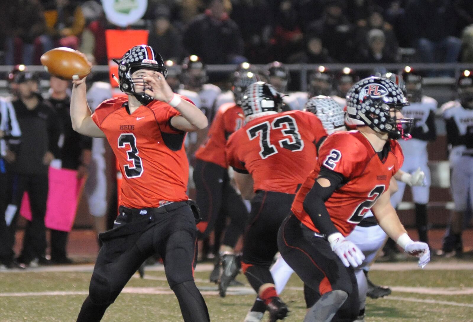 Loramie QB Collin Moore takes aim behind Devin Wehrman. McComb defeated Fort Loramie 28-14 in a D-VII high school football state semifinal at Wapakoneta on Saturday, Nov. 24, 2018. MARC PENDLETON / STAFF