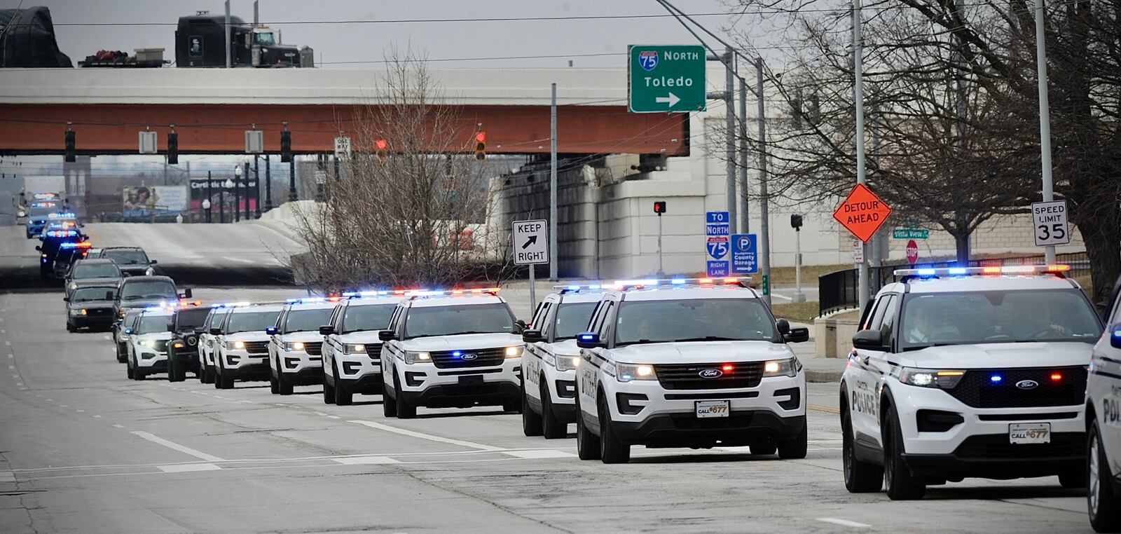 Processional for Dayton police officer who died of cancer traveling down Third Street by the safety building Thursday, February 24, 2022. MARSHALL GORBY \STAFF