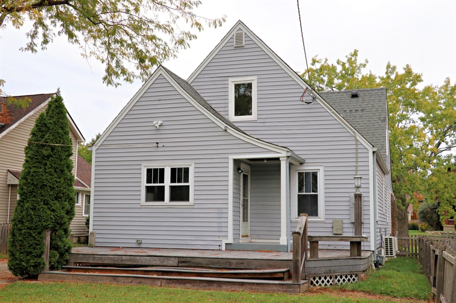 There is a large wooden deck off the small covered rear porch.