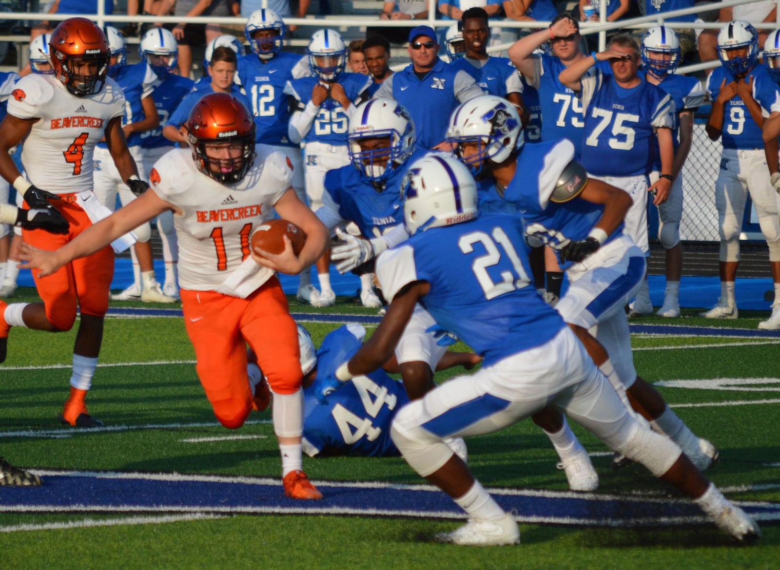 Beavercreek junior fullback Kaden Wenger beats Xenia defenders for a 64-yard run during Thursday night’s season opener. NICK DUDUKOVICH / CONTRIBUTED