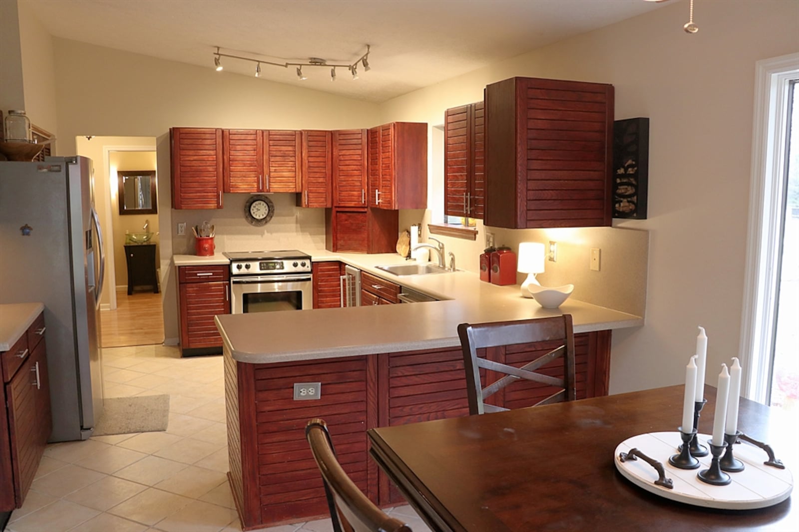 The kitchen has contemporary light-cherry cabinets with Corian counters. 