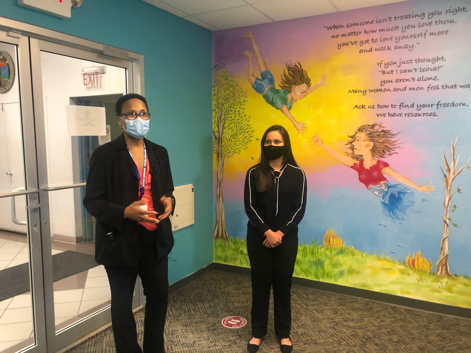 Sgt. Roberta Bailey and the artist from K12 who painted the mural in the lobby of the Family Justice Center. CORNELIUS FROLIK / STAFF