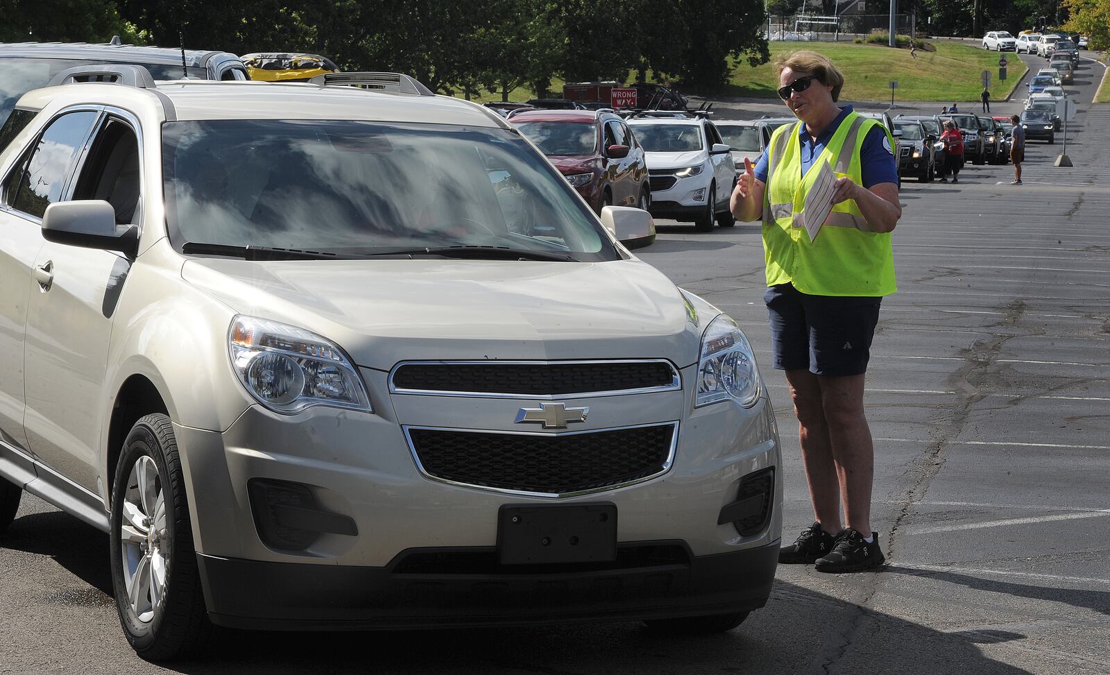 Virginia Wonderly, with the University of Dayton Parking Services, welcomes families Wednesday, Aug 18, 2021 of  the freshman class and helps guide them to their dorms. MARSHALL GORBY\STAFF 