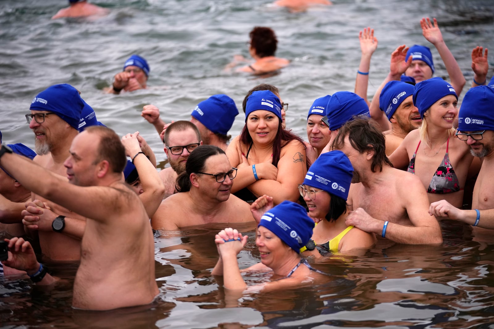 Some of 2461 polar swimmers wait in the water to set a world record for the largest polar bear dip at a lake in Most, Czech Republic, Saturday, March 1, 2025. (AP Photo/Petr David Josek)