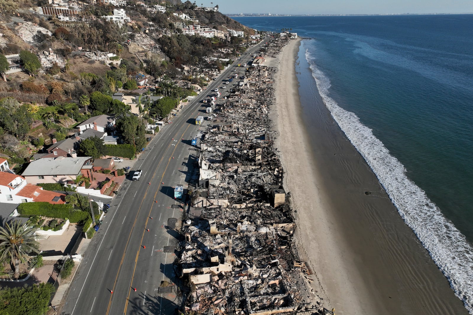 An aerial view shows the devastation from the Palisades Fire on beachfront homes Wednesday, Jan. 15, 2025 in Malibu, Calif. (AP Photo/Jae C. Hong)