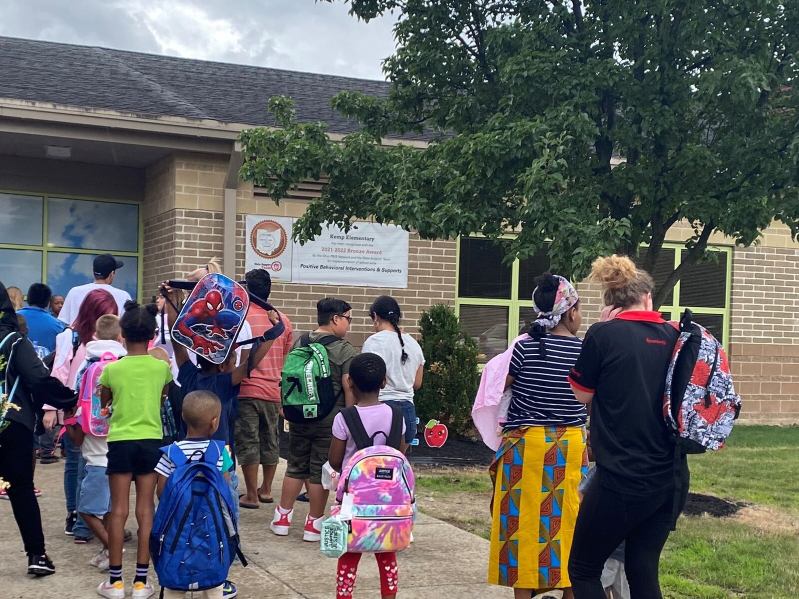 Kids and parents lined up before the first day of school started at Kemp Elementary, part of Dayton Public Schools, on Monday, Aug. 14. Eileen McClory / Staff