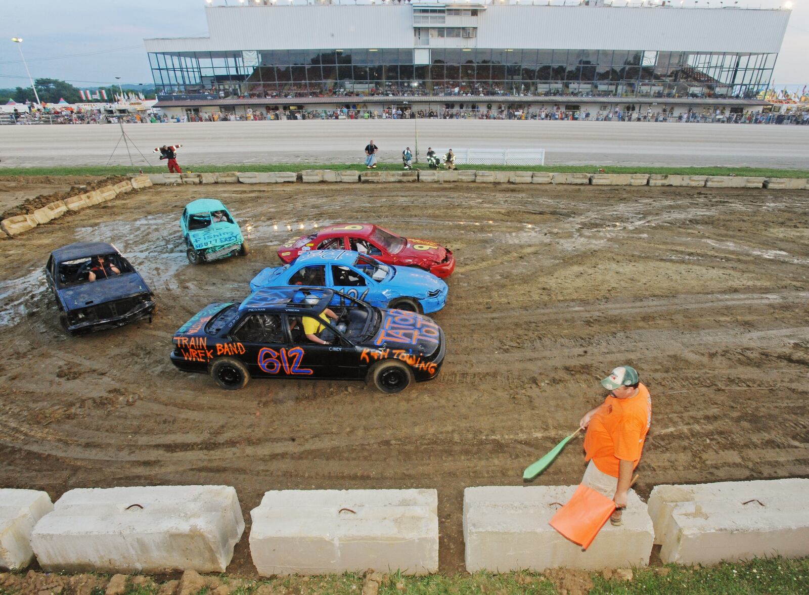 Vehicles drive around in a figure eight on Wednesday, July 21, 2010, during the demolition derby at the Warren County Fair in Lebanon. See more county fair photos online. Staff photo by Apryl Pilolli